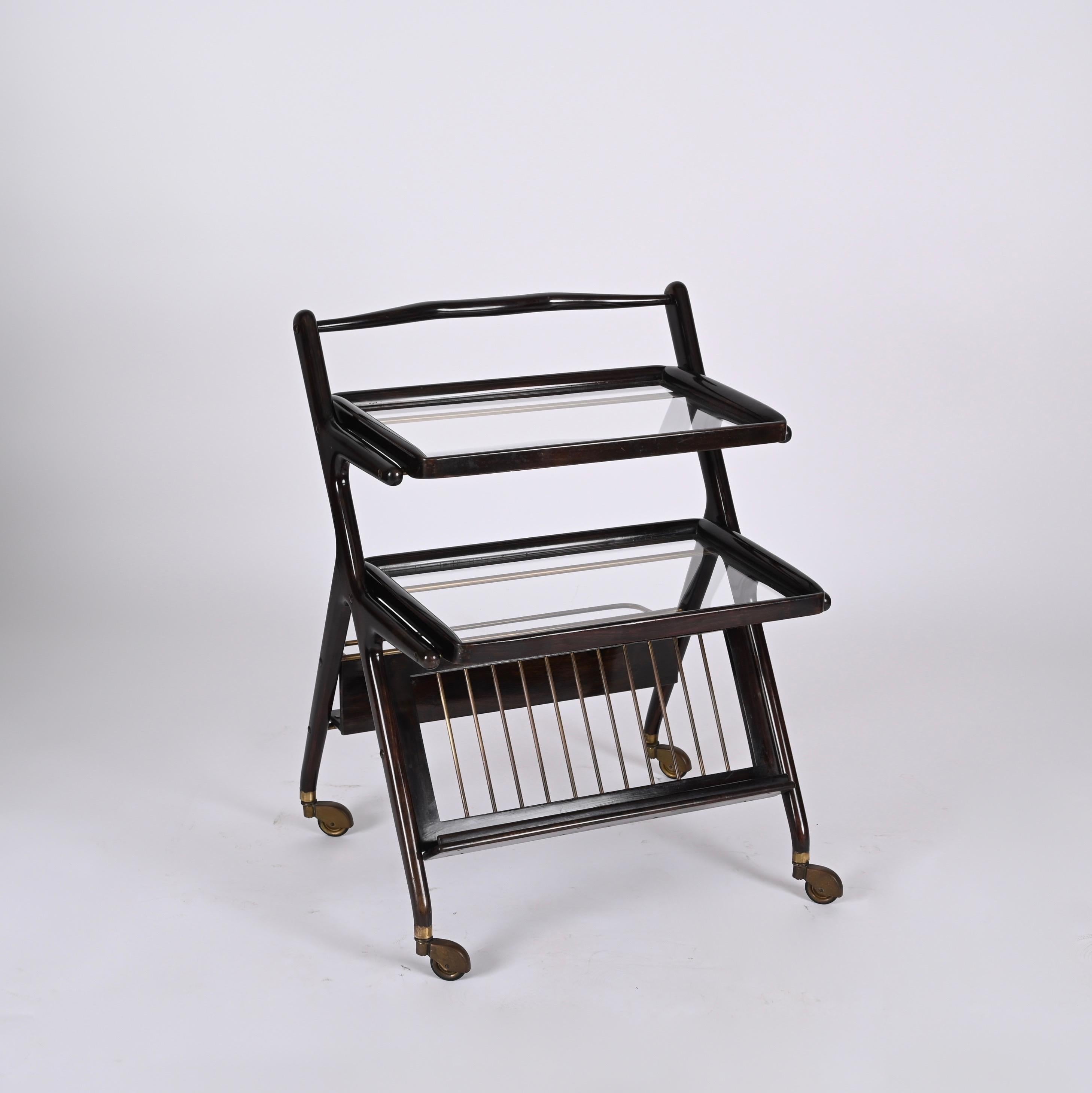 Fantastic mid century wood bar trolley. It was produced by Cesare Lacca in Italy during 1950s. 

This wonderful piece comes with two glass removable trays and an ergonomic bottle rack.

The lines of this piece make it perfect for a