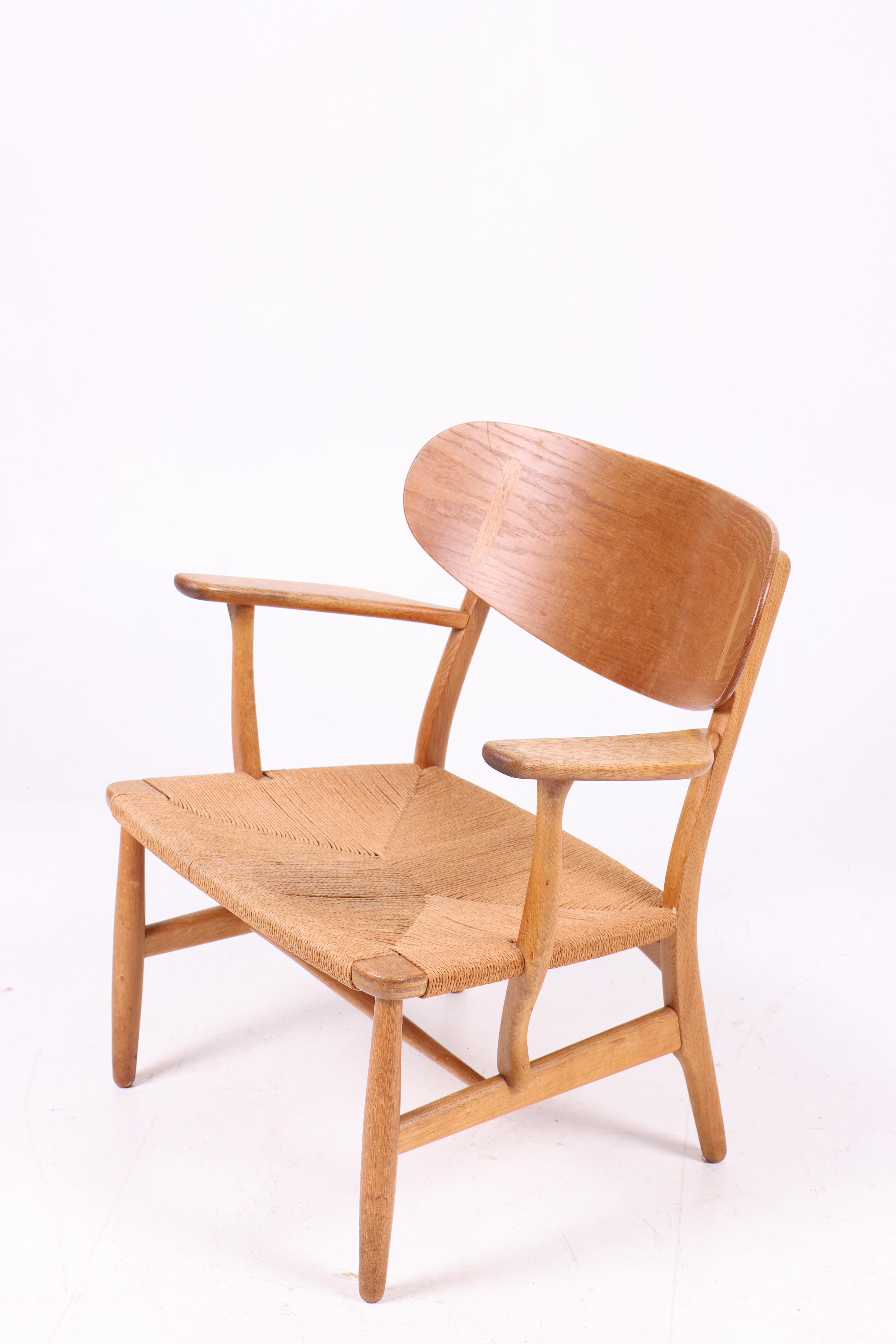 Danish Midcentury CH-22 Lounge Chair in Teak and Oak by Hans Wegner, 1960s For Sale