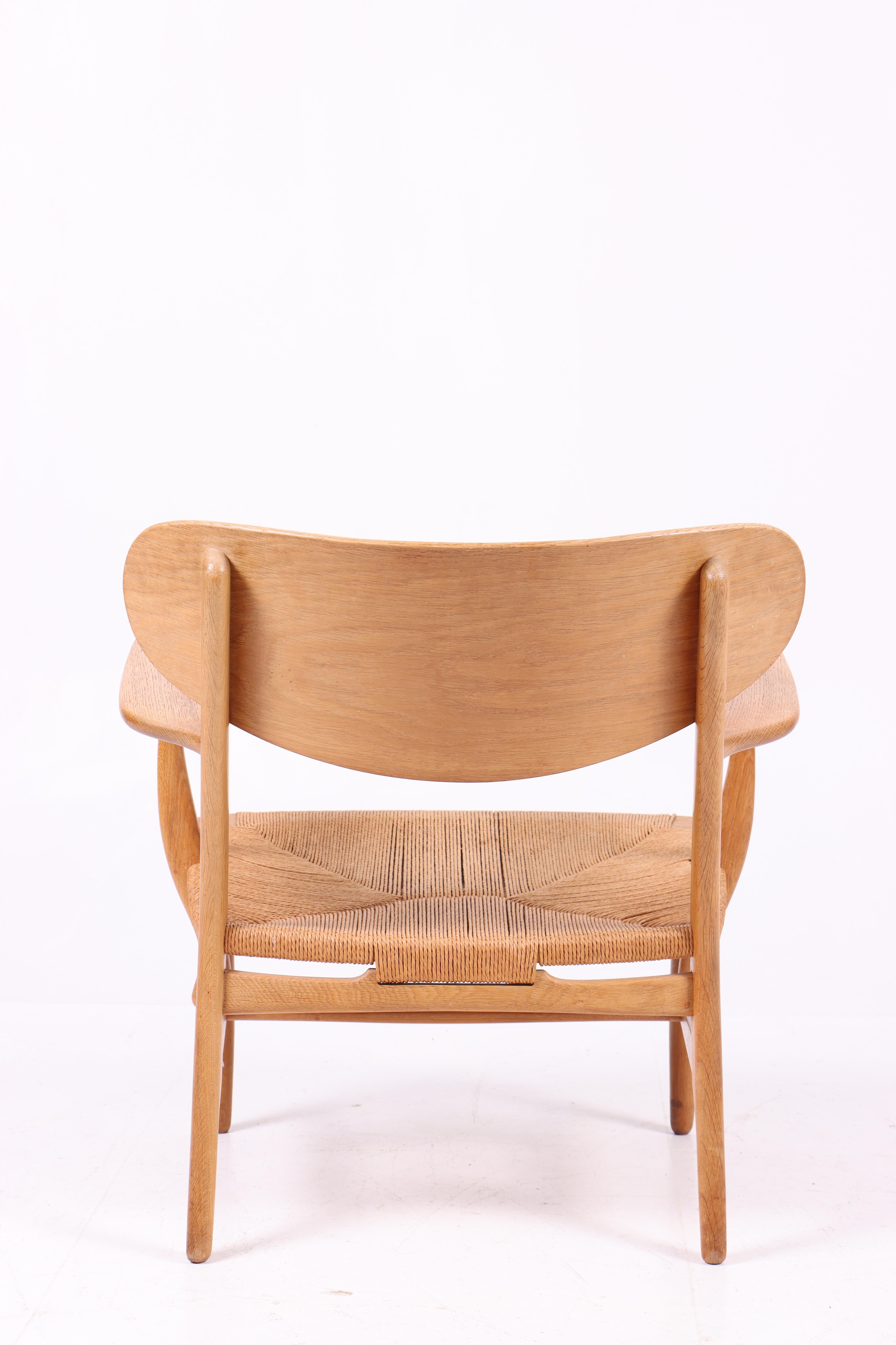 Mid-20th Century Midcentury CH-22 Lounge Chair in Teak and Oak by Hans Wegner, 1960s For Sale
