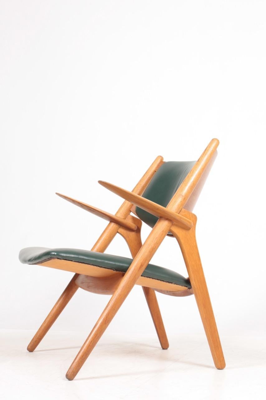 Mid-20th Century Midcentury CH-28 Lounge Chair in Oak and Patinated Leather by Hans Wegner, 1960s