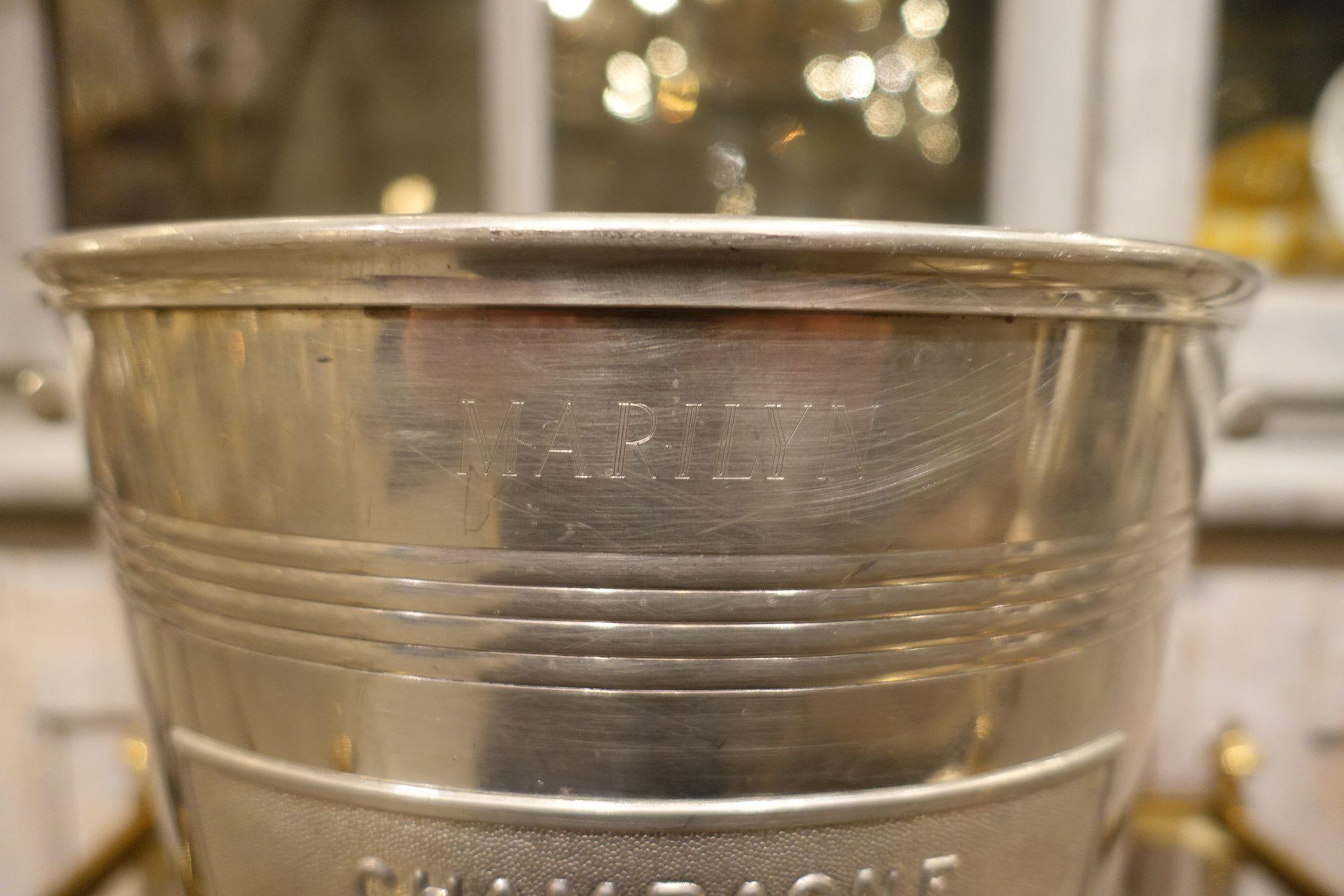 Huge and handsome magnum champagne cooler / bucket, from the house of Piper. Polished quality tin, with the Piper name as well as Marylin Monroe’s name and address on the sides! A lovely ornate bunch of grapes also decorates the side.

In 1953, the
