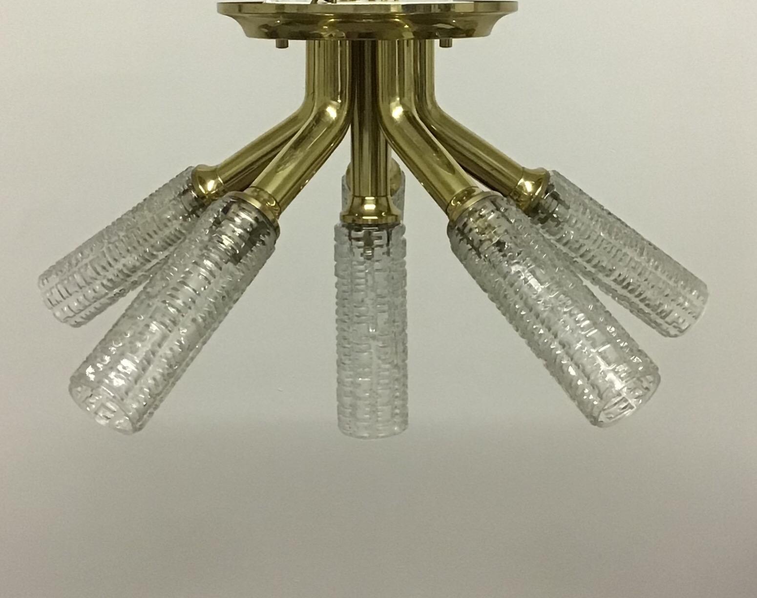 A mid-century chandelier by Kalmar, Austria, Vienna, circa 1960s.
Made of gilt brass and six textured glass shades
Socket: 6 x e 14 Edison base for standard screw bulbs.


 