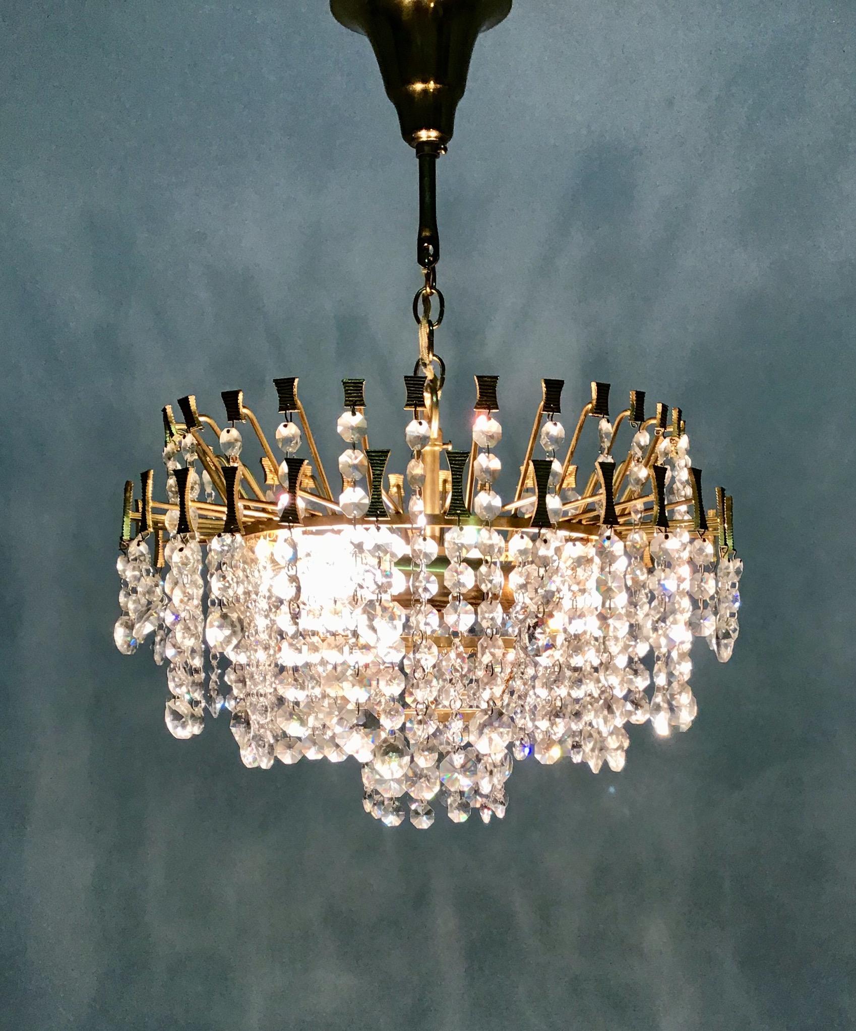 A mid - century three-light gilt brass and Swarovski crystal chandelier by Palwa, Germany, circa 1960s.
Socket: Three e 14 (Edison) for standard screw bulbs.
Excellent condition.