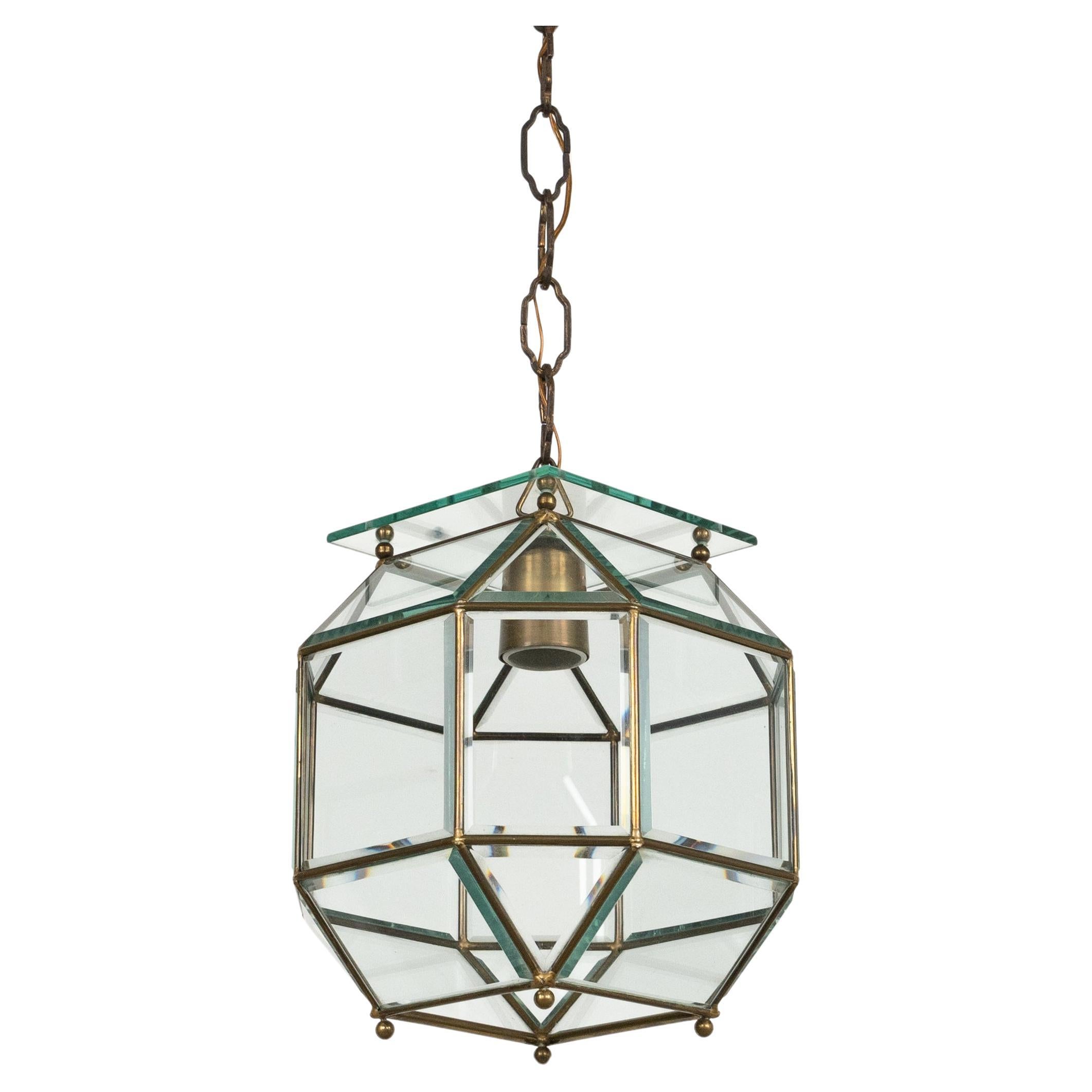 Midcentury amazing chandelier lantern in brass and beveled glass in the style of Adolf Loos.

Made in Italy in the 1950s.

The stunning and clear cut pendant shows twenty-four facetted clear glasses in a brass frame. 

Measures: 
Height with chain