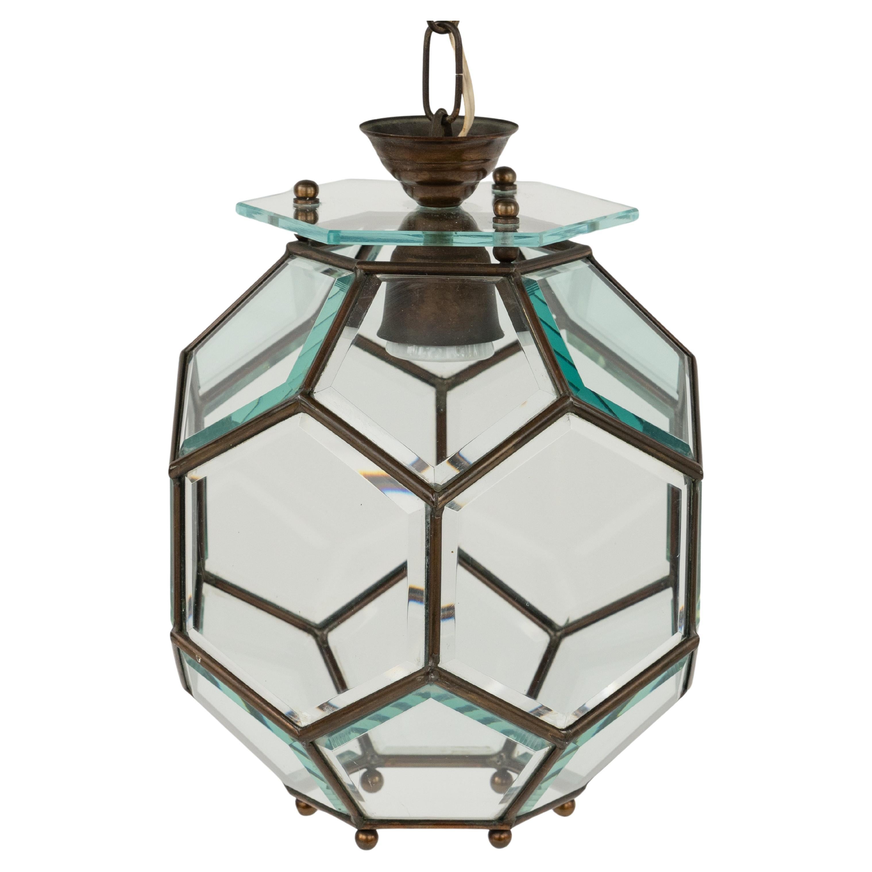 Midcentury amazing chandelier lantern in brass and beveled glass in the style of Adolf Loos.  

Made in Italy in the 1950s.  

The stunning and clear cut pendant shows eighteen facetted clear glasses in a brass frame.   

Measures:  
Height with