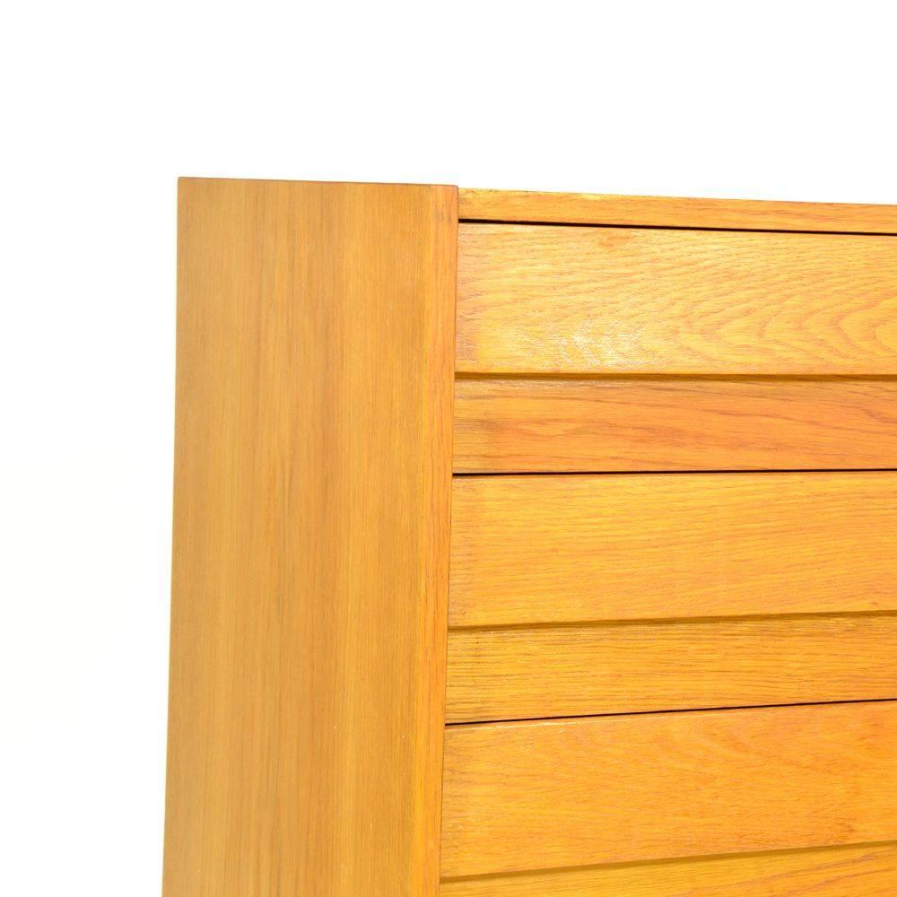 Wooden chest of drawers manufactured by Interiér Praha, designed by Jirí Jiroutek. Wooden construction, oak veneer, drawers are made from plastic, the front part of drawers made ??of sprayed wood. In perfect original condition, wood only refreshed.