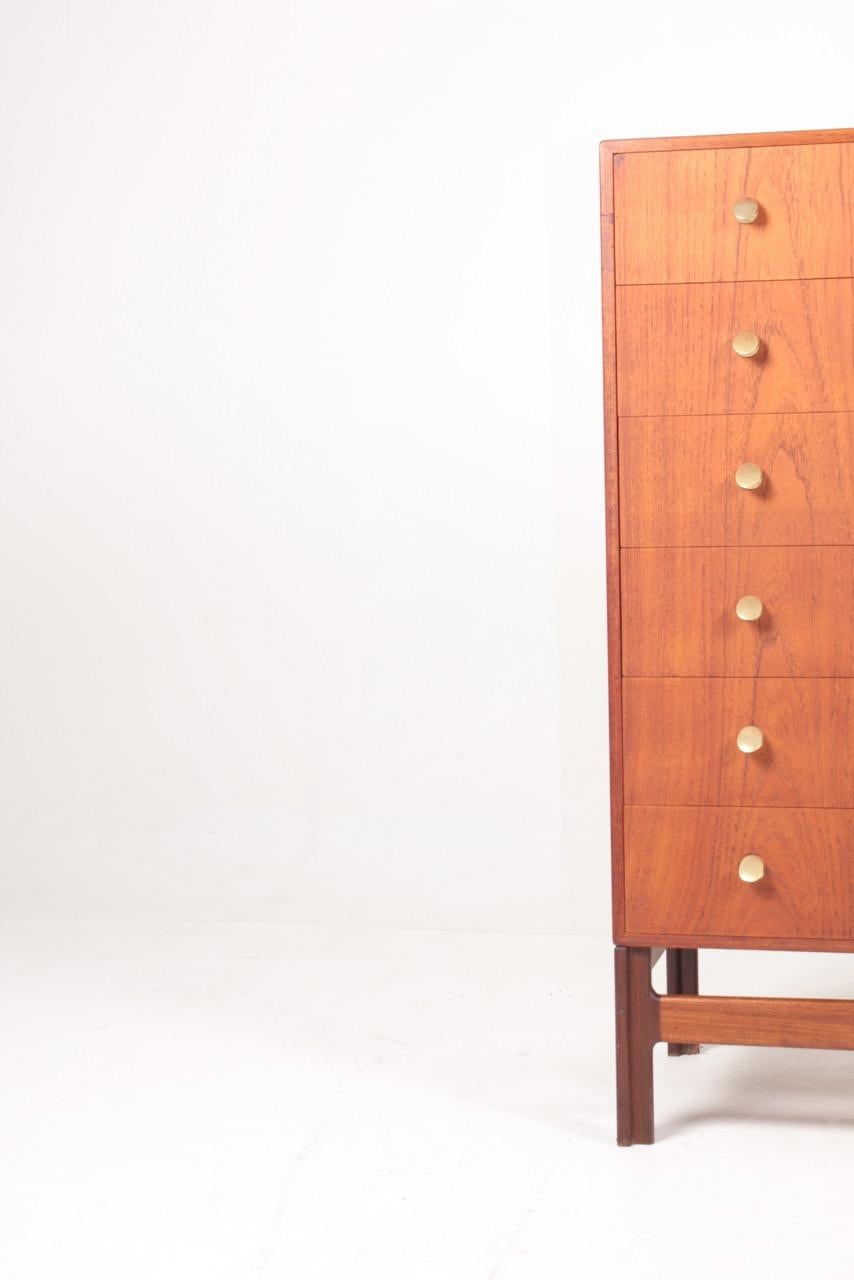 Chest of drawers in teak with brass handles, designed and made in Denmark. Great original condition.