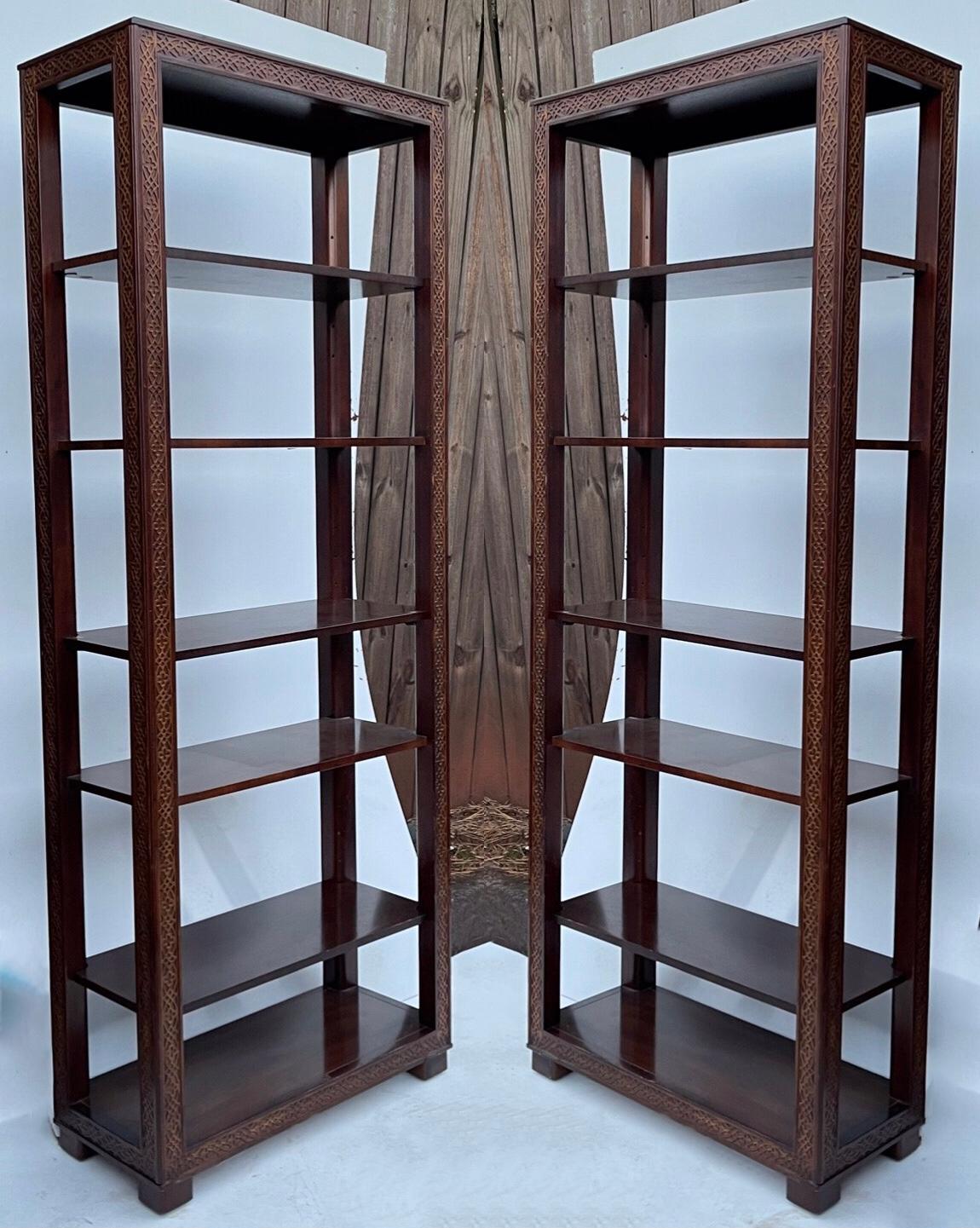 This is a wonderful pair of Chinese chippendale style carved mahogany etageres or shelves. Note the frettework running down the frame. One half of the shelves are fixed, and the others are adjustable. These are classic pieces that are hard to find!