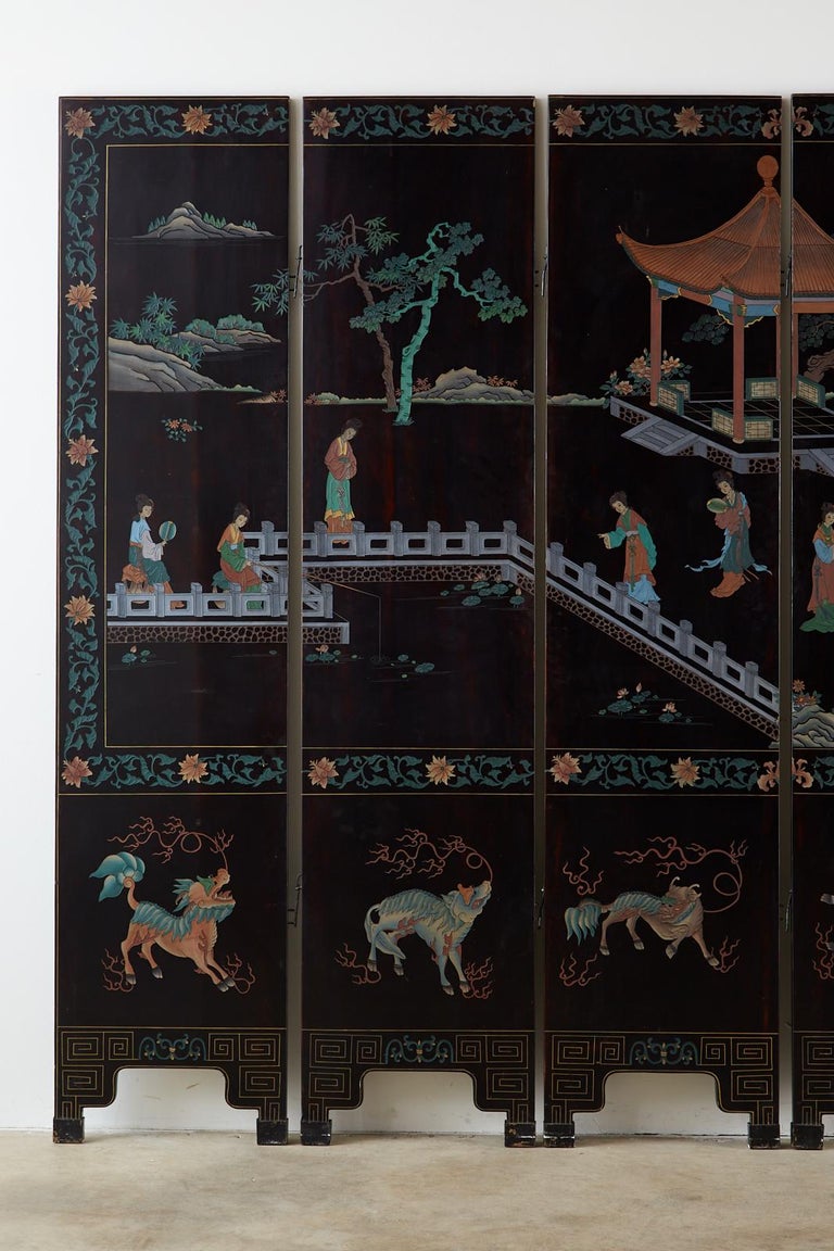 Stunning midcentury Chinese export six-panel lacquered Coromandel screen featuring a pavilion landscape with beauties. Beautifully crafted with incised lacquer painted with surreal colors that stand out boldly against the smooth black lacquer. The