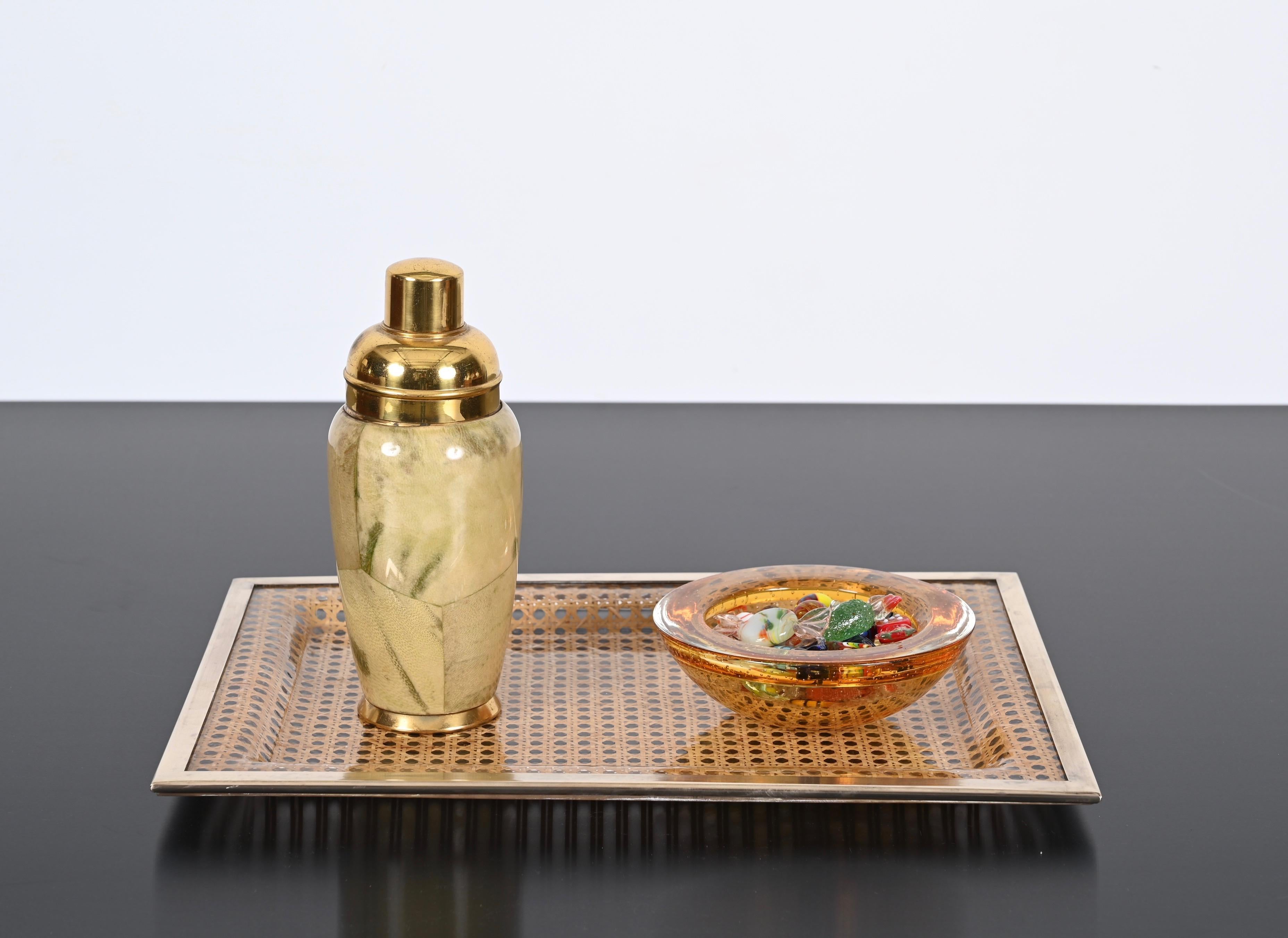 Wonderful midcentury rectangular serving tray in lucite Vienna straw and brass. This amazing piece was designed in France during the 1970s, following the style of Christian Dior.

This large and elegant midcentury serving tray consists of a large