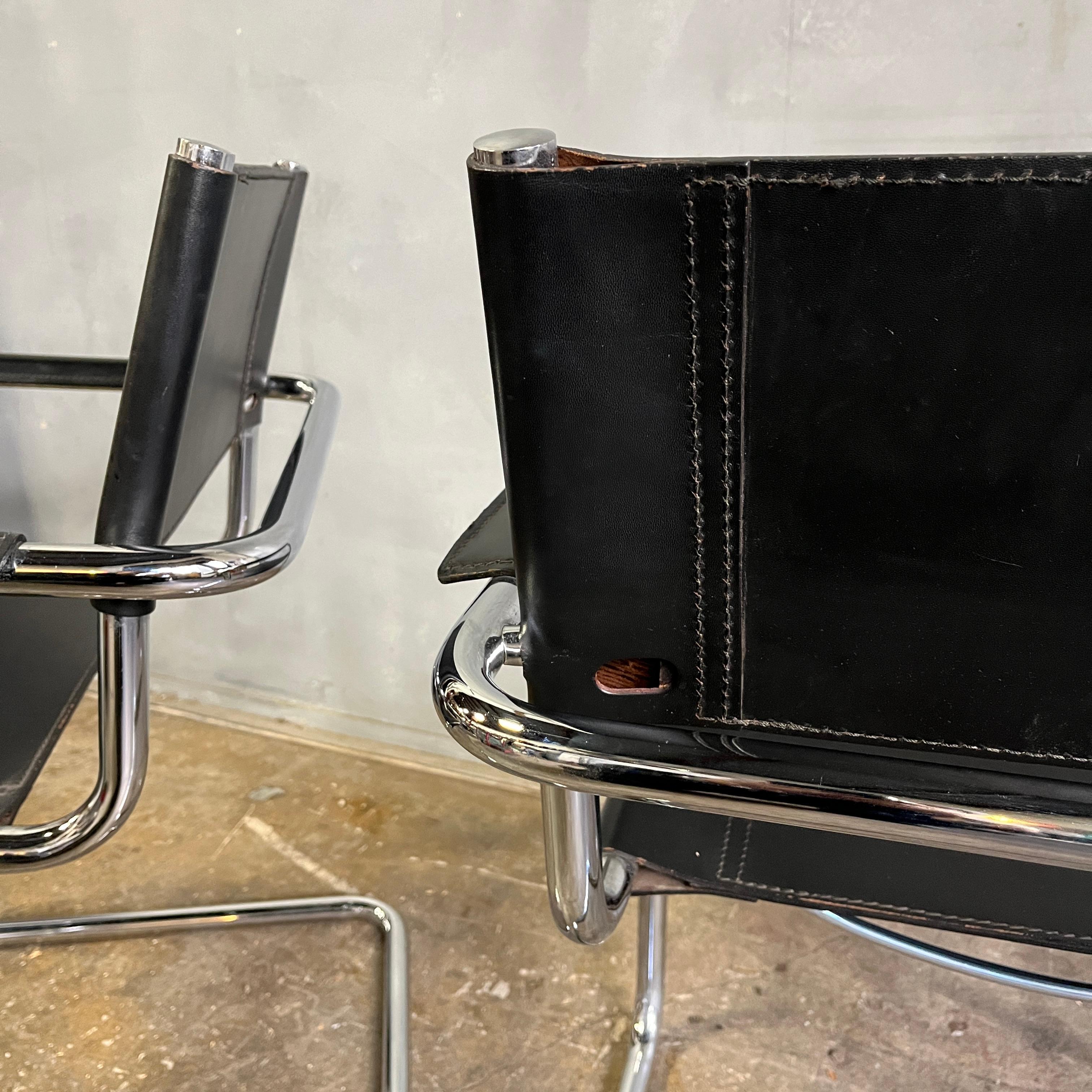 Iconic Bauhaus cantilevered armchairs of chrome tubular steel with black leather sling seat and back and black leather armrests in near pristine condition. Designed by Mart Stam in 1927, chairs of this style were the first cantilevered chairs in