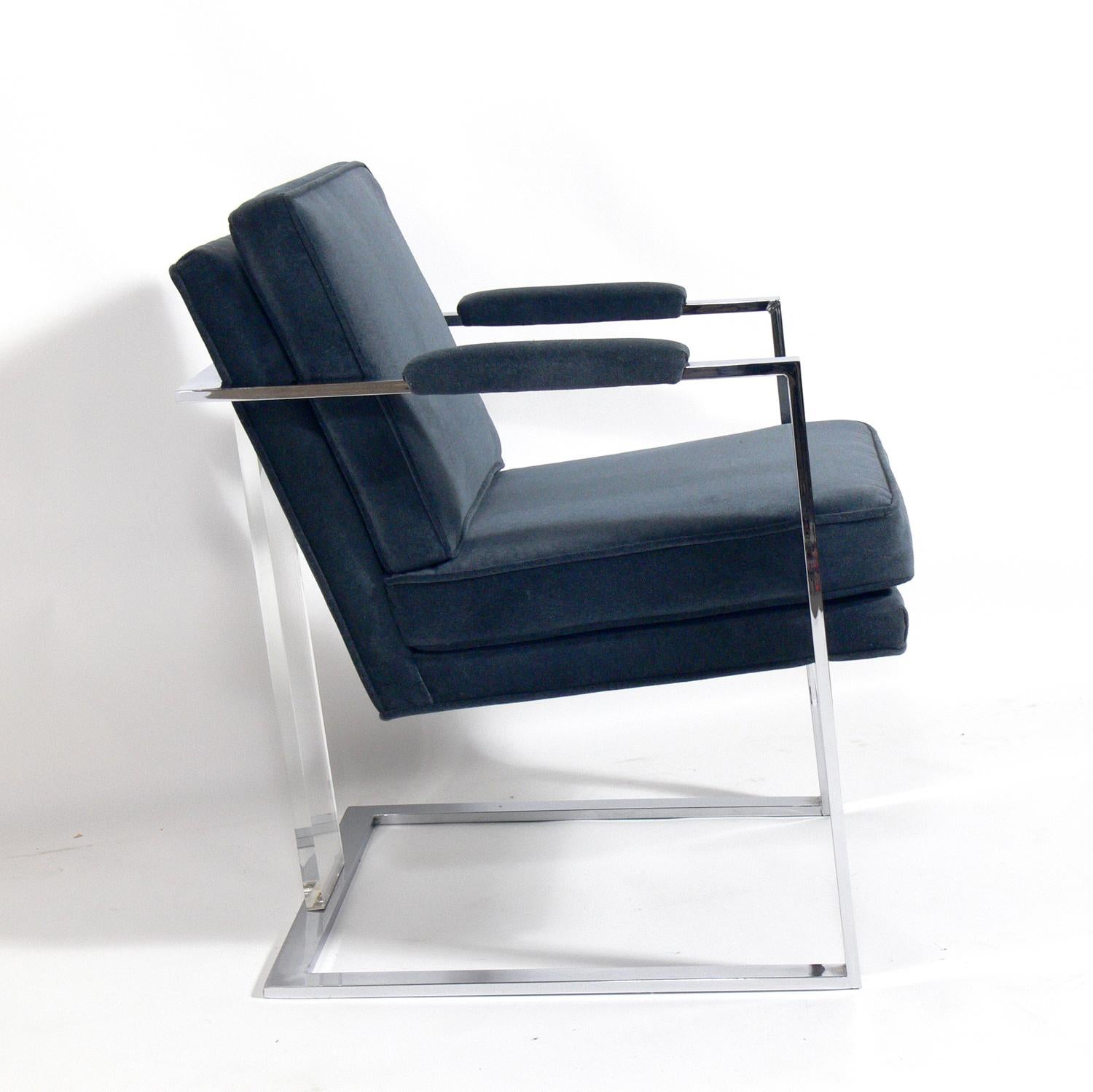 Midcentury chrome and Lucite lounge chair, attributed to Milo Baughman, American, circa 1960s. This chair has been recently reupholstered in a velvety slate blue color upholstery.
