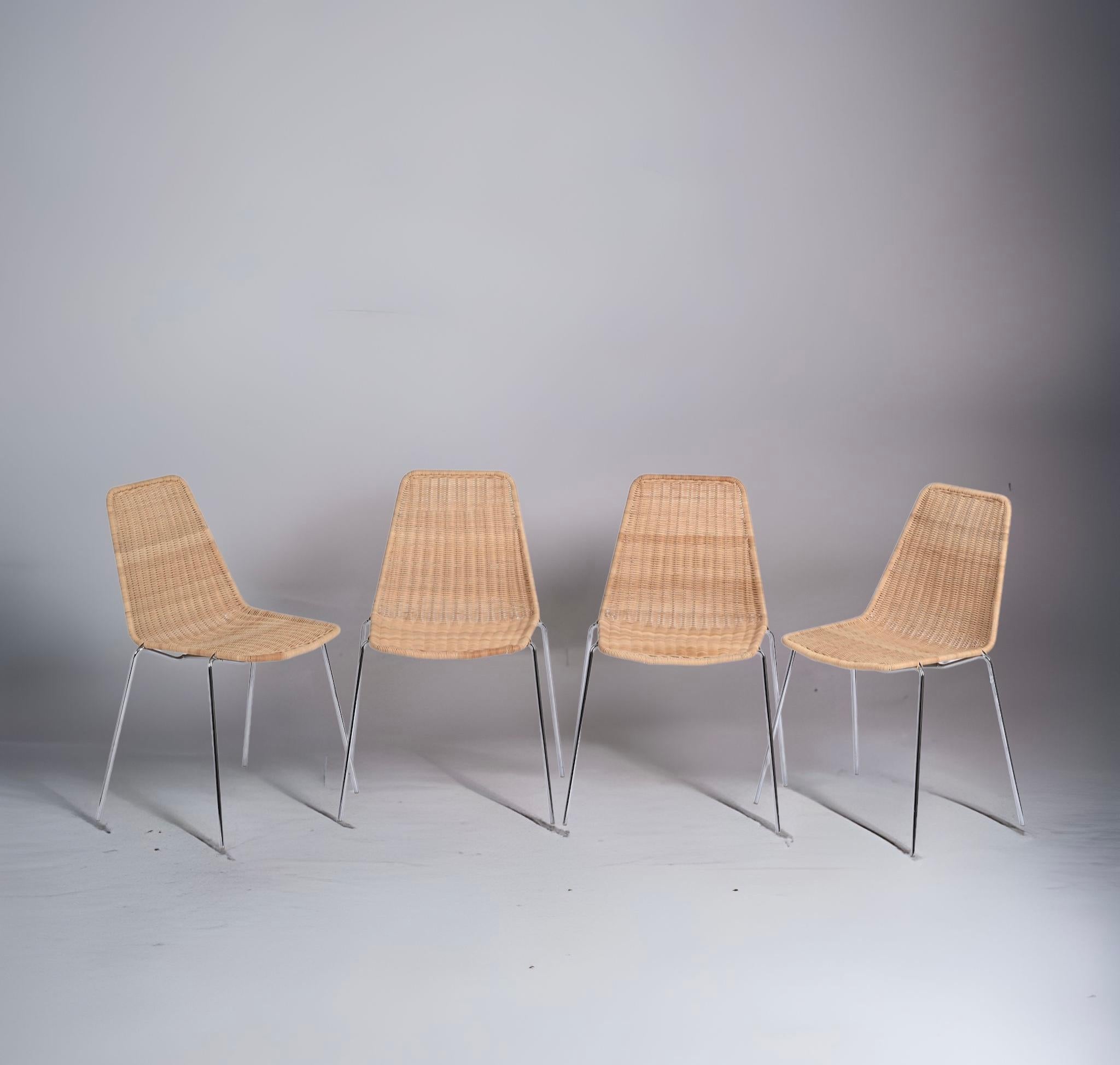 Beautiful midcentury set of four wicker and chromed metal Italian chairs. These amazing pieces were produced in Italy during the 1970s and attributed to designers Franco Campi e Carlo Graffi.

Each seat and back are made of hand-woven rattan with