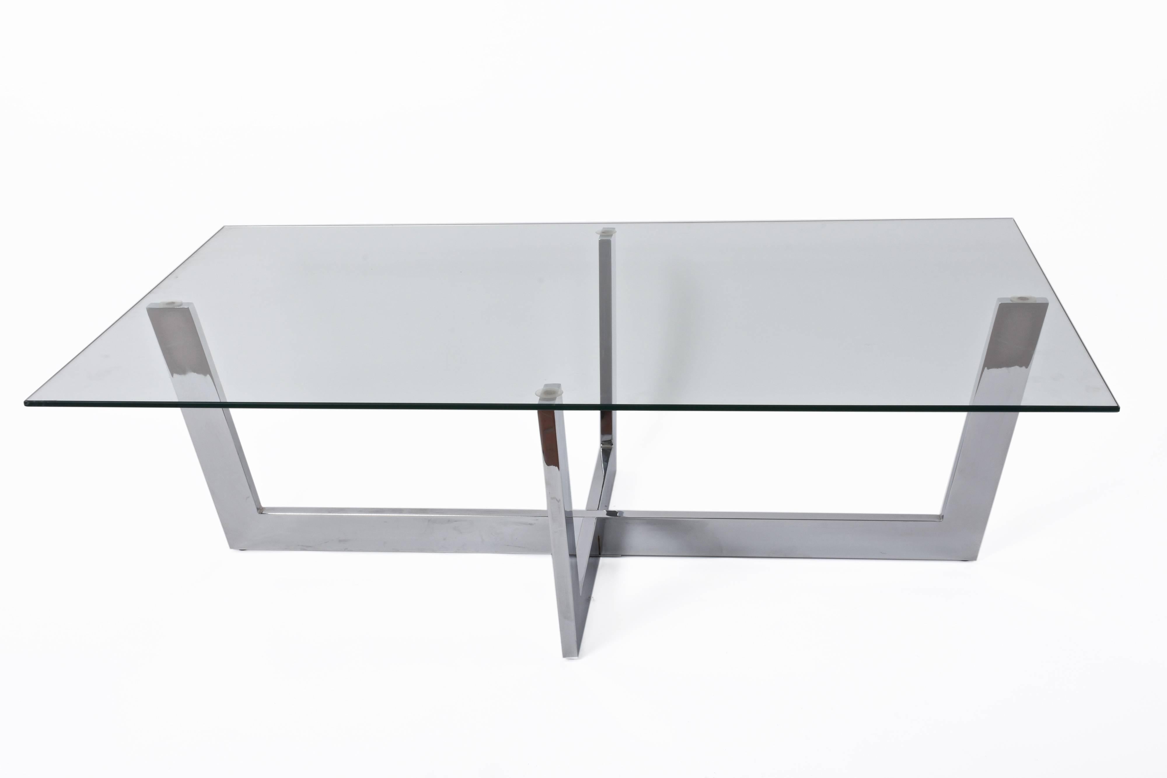 Wonderful chromed steel coffee table with crystal glass top. This amazing piece was produced in Italy during 1970s. 

This midcentury masterpiece of minimal design is lovely because of the straight lines of both the glass top and chrome steel