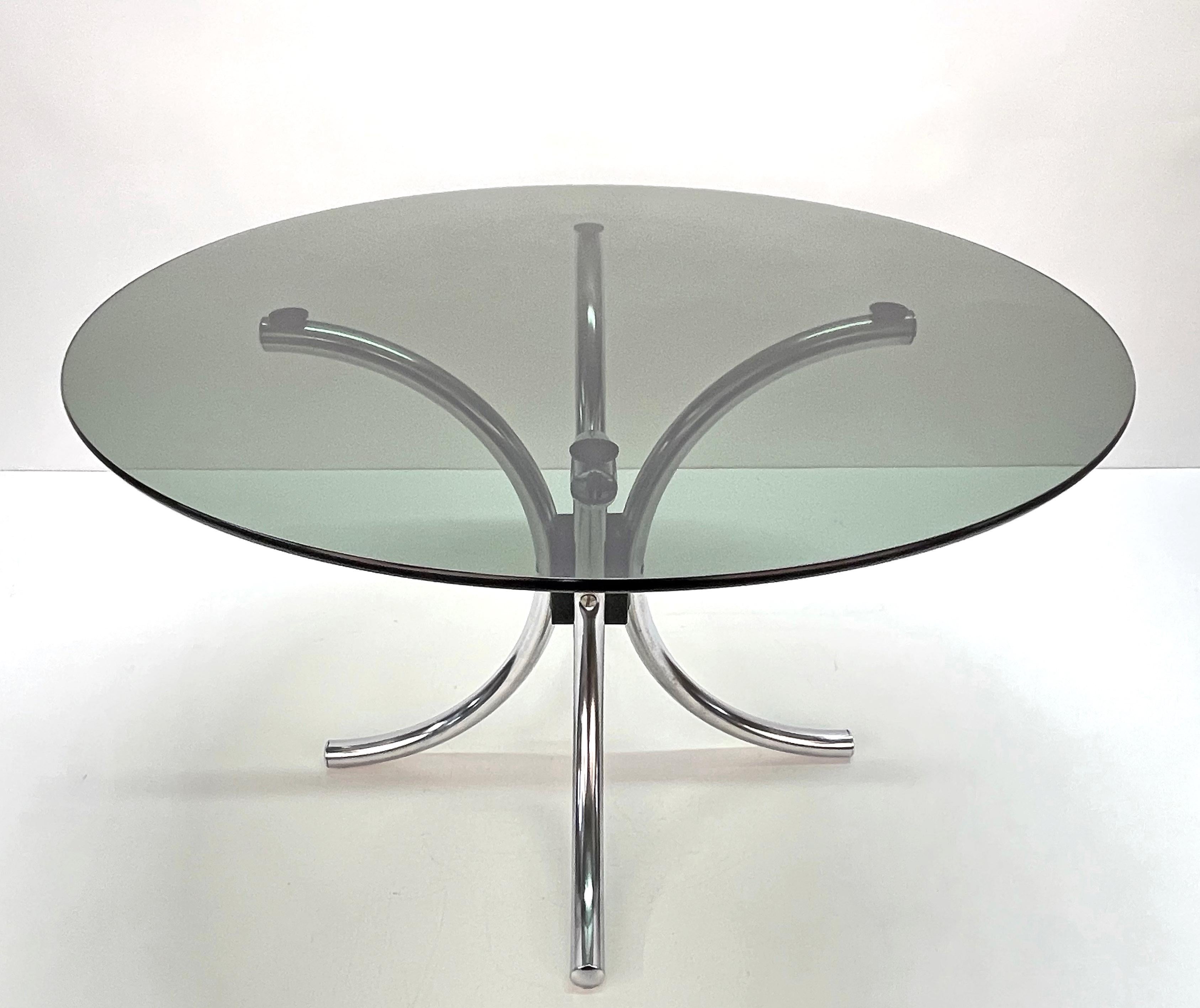 Beautiful coffee table in chromed steel with smoked round glass top. This fantastic item was produced in Italy during the 1960s.

This atomic-style Italian coffee table features a base made of four chromed metal tubes and a smoked glass top.

A