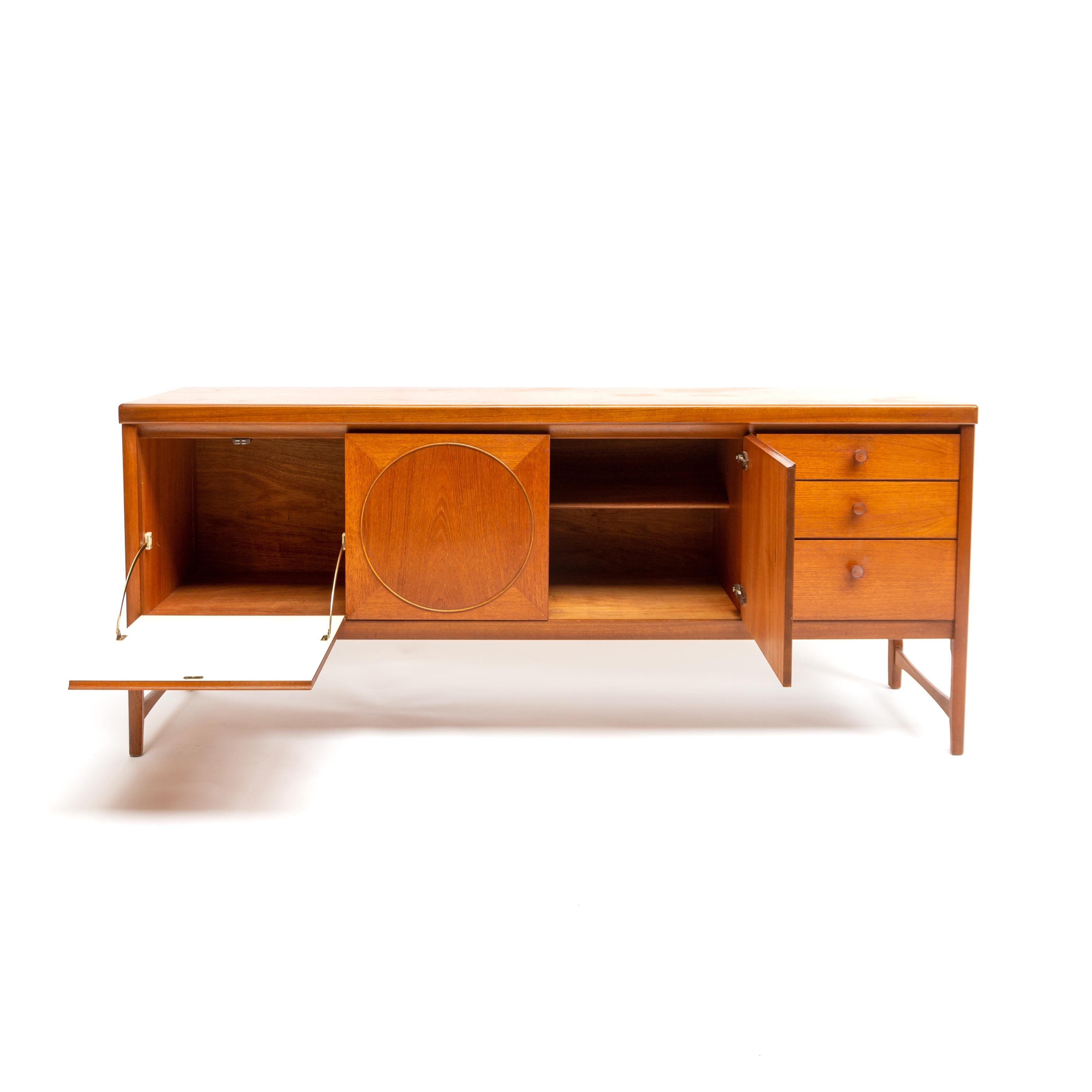 Very beautiful original teak sideboard, dresser or credenza. Made in the UK by Nathan Furniture and designed by Patrick Lee. 
A superb Nathan ‘circles’ sideboard. It is in very good condition with very minor signs of expected wear. The drawers are