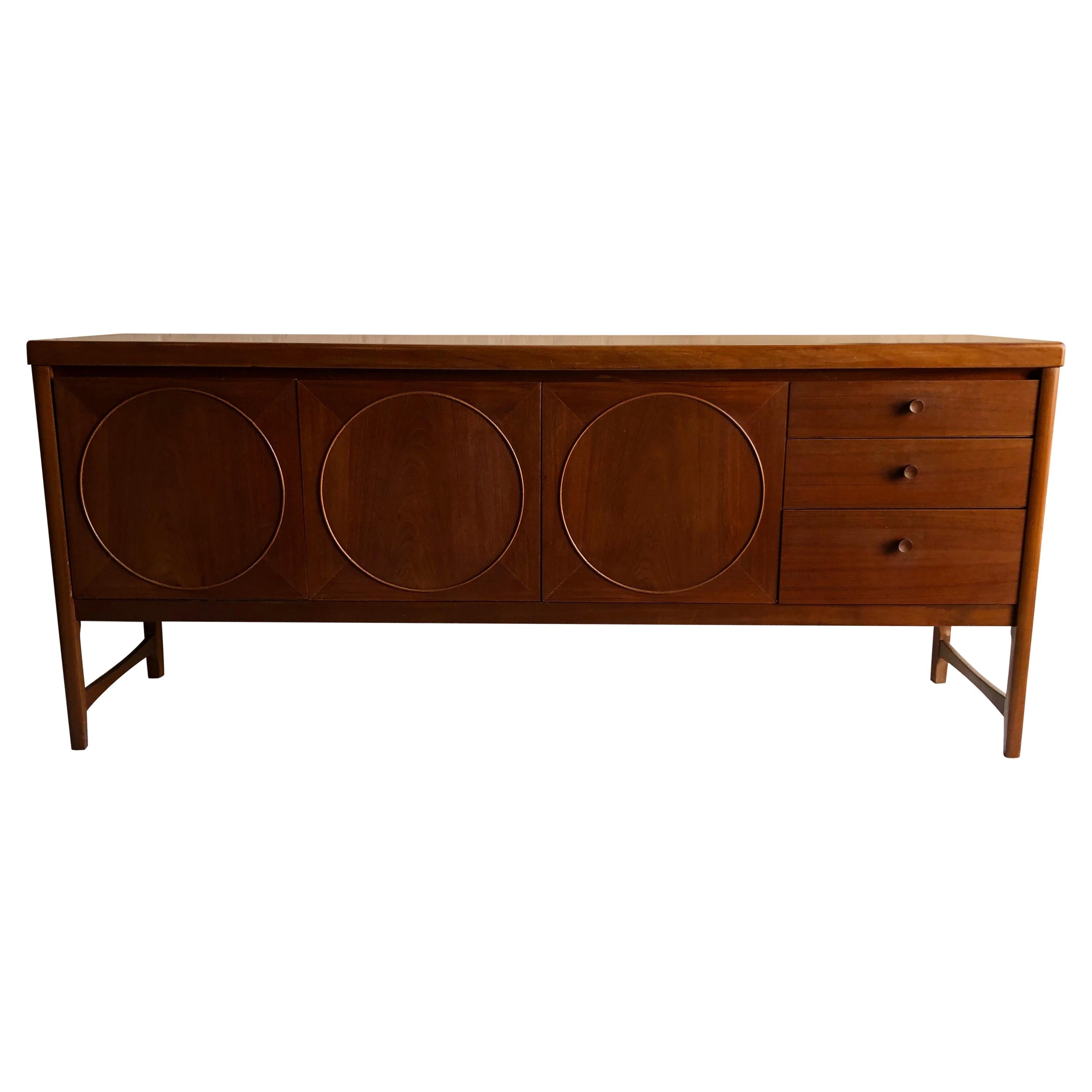 Midcentury circles teak sideboard by Nathan Furniture, 1960s

Absolutely beautiful example of the Classic ‘Circles’ sideboard by Nathan Furniture. Designed by Patrick Lee
Consists of 3 x drawers, drop down drinks cabinet and 2-door