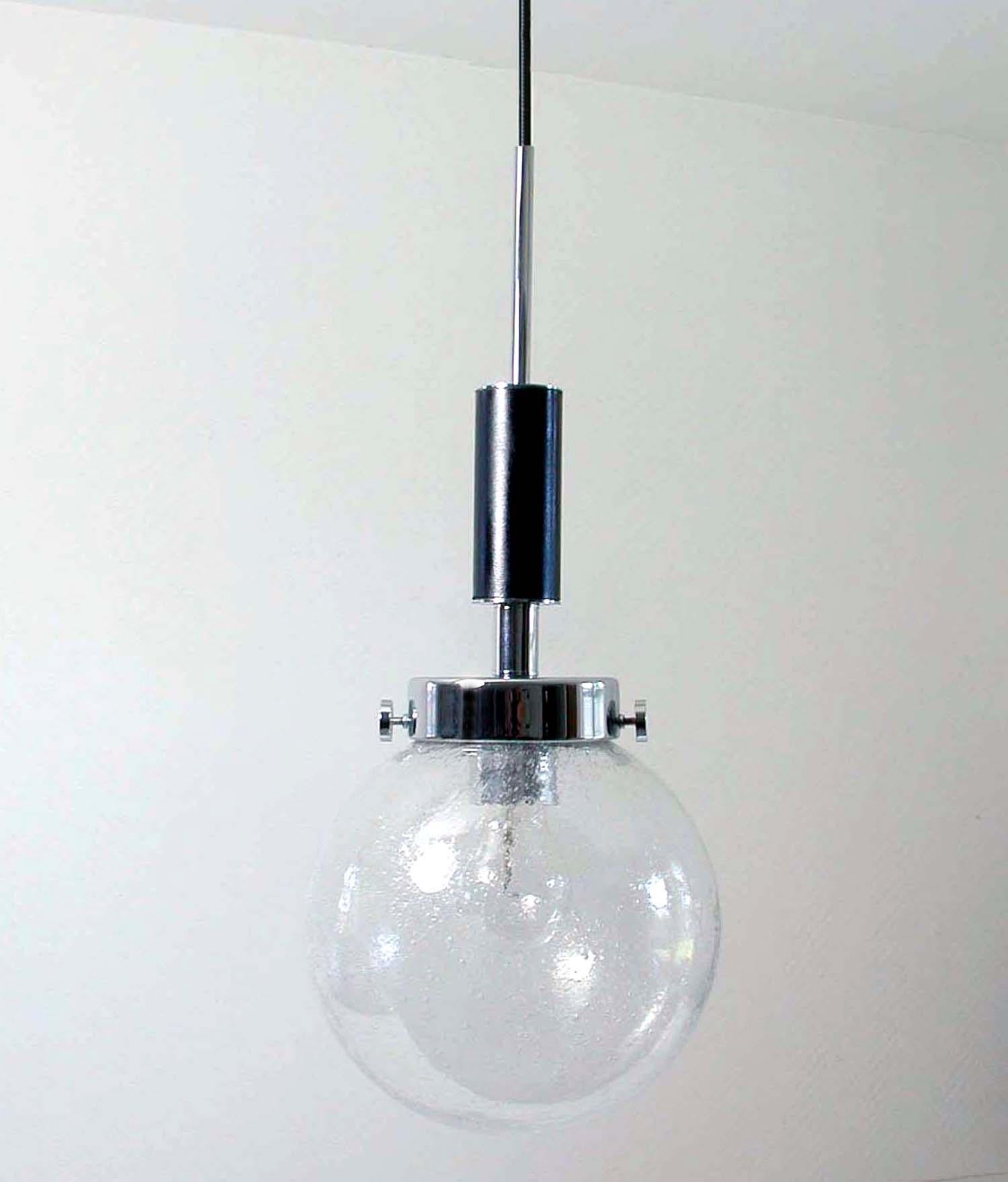 This pendant was designed and manufactured in Germany in the late 1960s. It is made of chrome and black faux leather and has got a clear glass bubble lamp shade.

There are 4 pendants available.

Length of wiring can be customized. The height is