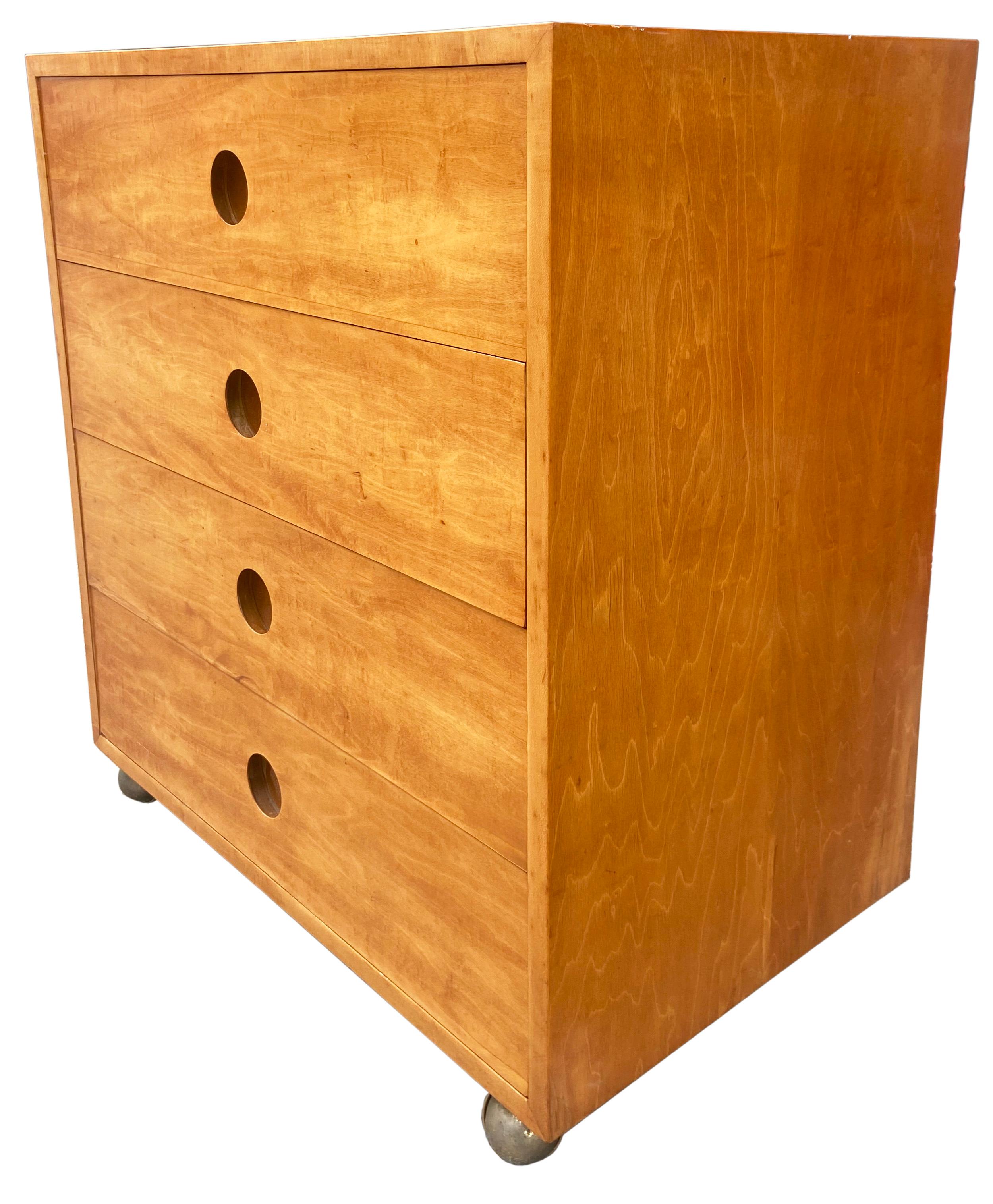 Mid century chest of drawers on rolling base by Clifford Pascoe for Artek. Pascoe and the Aalto's opened a retail location (Artek-Pascoe Inc.) in NYC c1940's. This cabinet was part of the collection. Beautiful patina with the heavily figured Finland