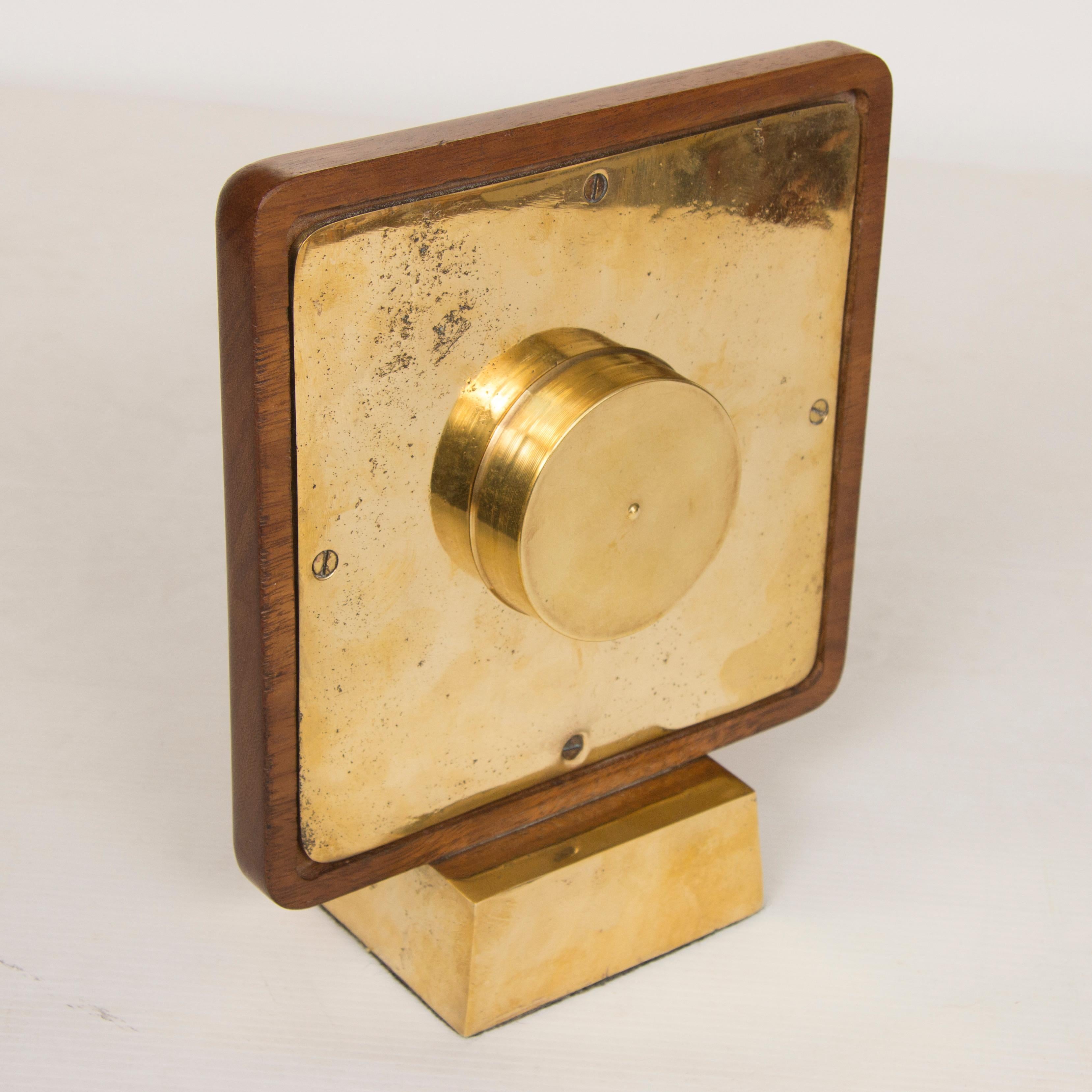Midcentury clock.
Very impressive midcentury clock, heavy gilt bronze base supporting a Swiss made gilt bronze clock face in a beautiful solid teak frame.
The clock movement has been replaced with a battery operated movement, so it keeps perfect