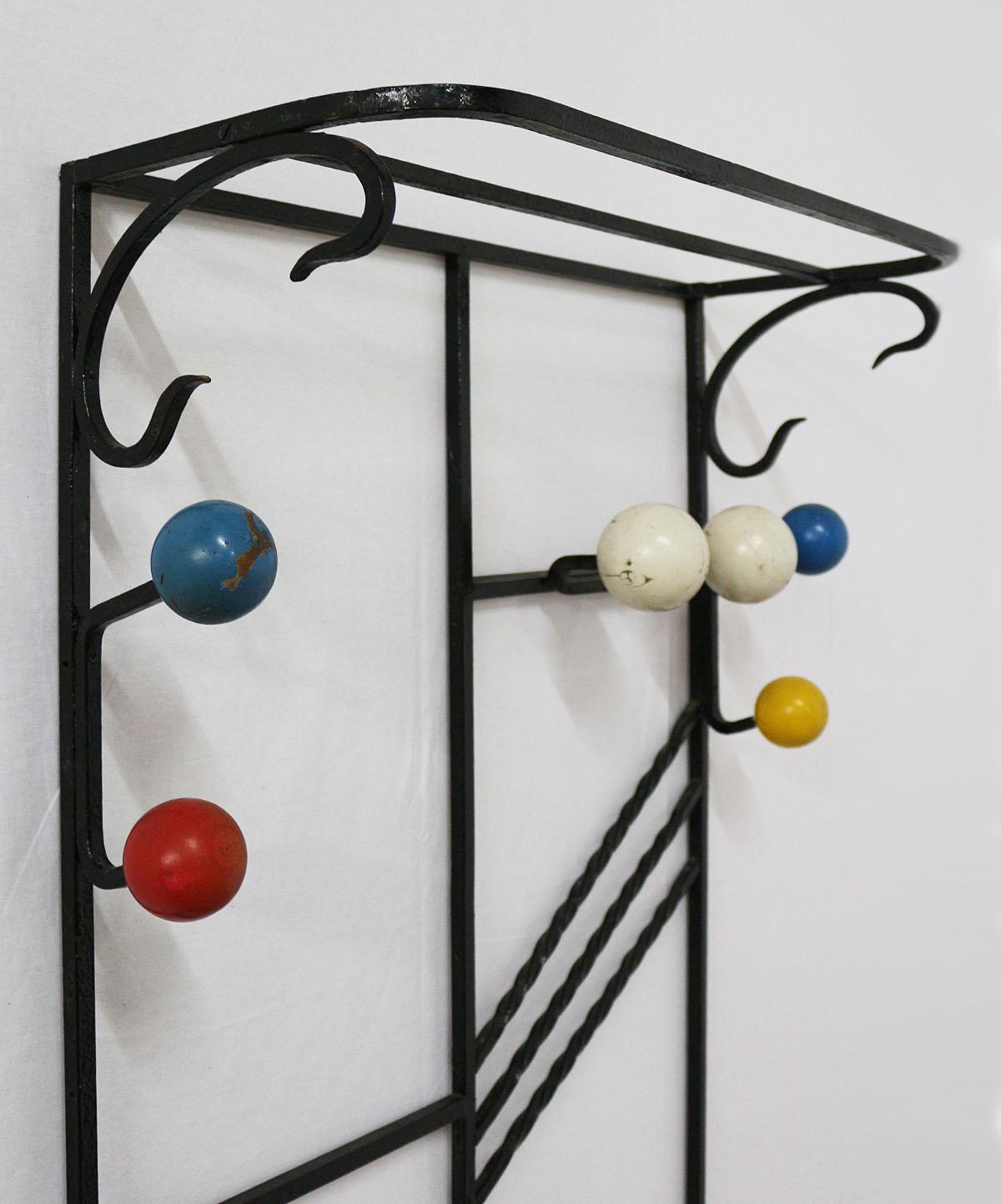 Vintage original French midcentury coat and hat rack hall stand
Designed by Roger Feraud. 
Lacquered metal with colored wooden balls. 
Unusual model. 
Architectural.