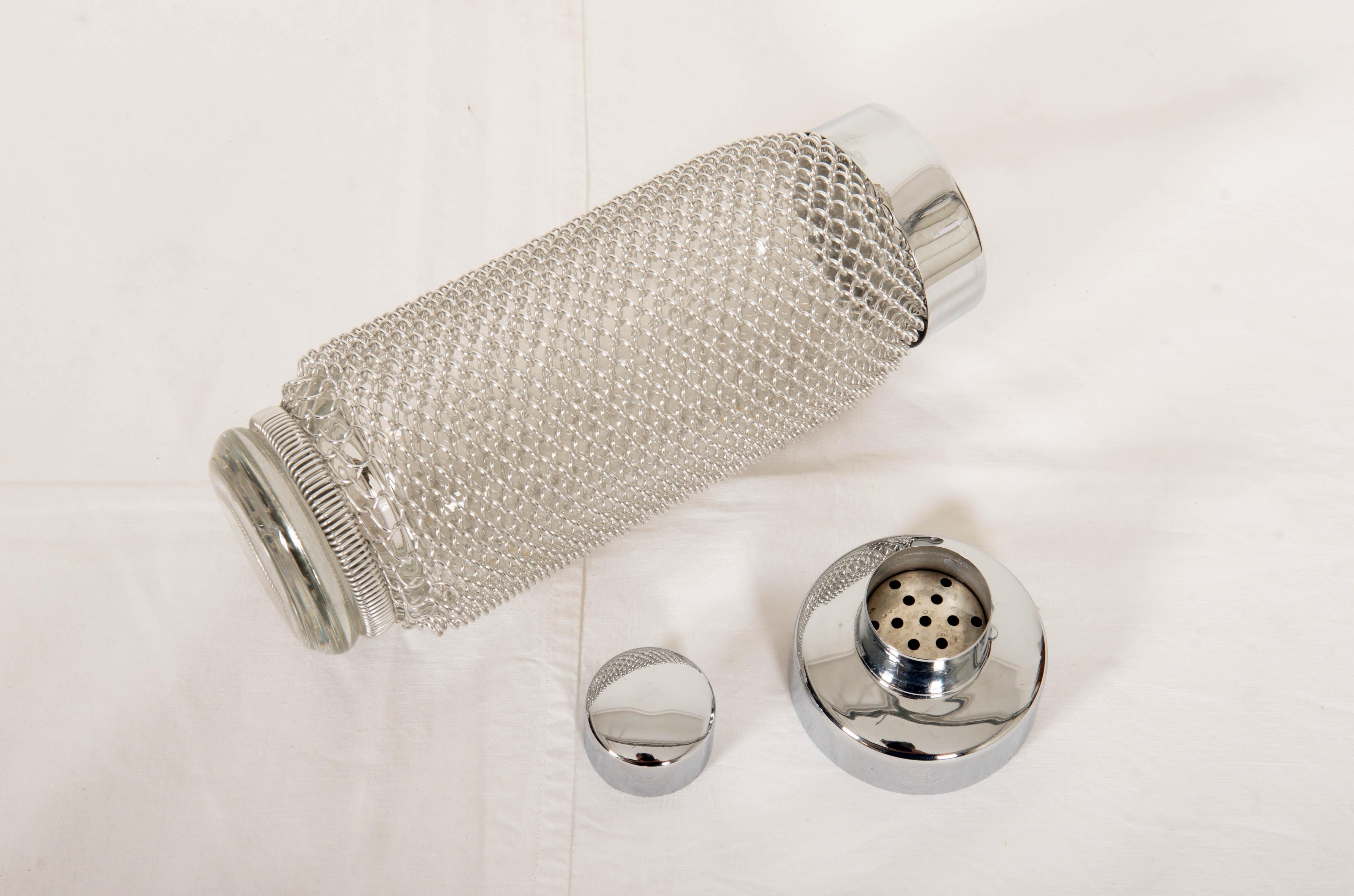 Glass bottle with wire-netting and a cover made in the early 1970s.