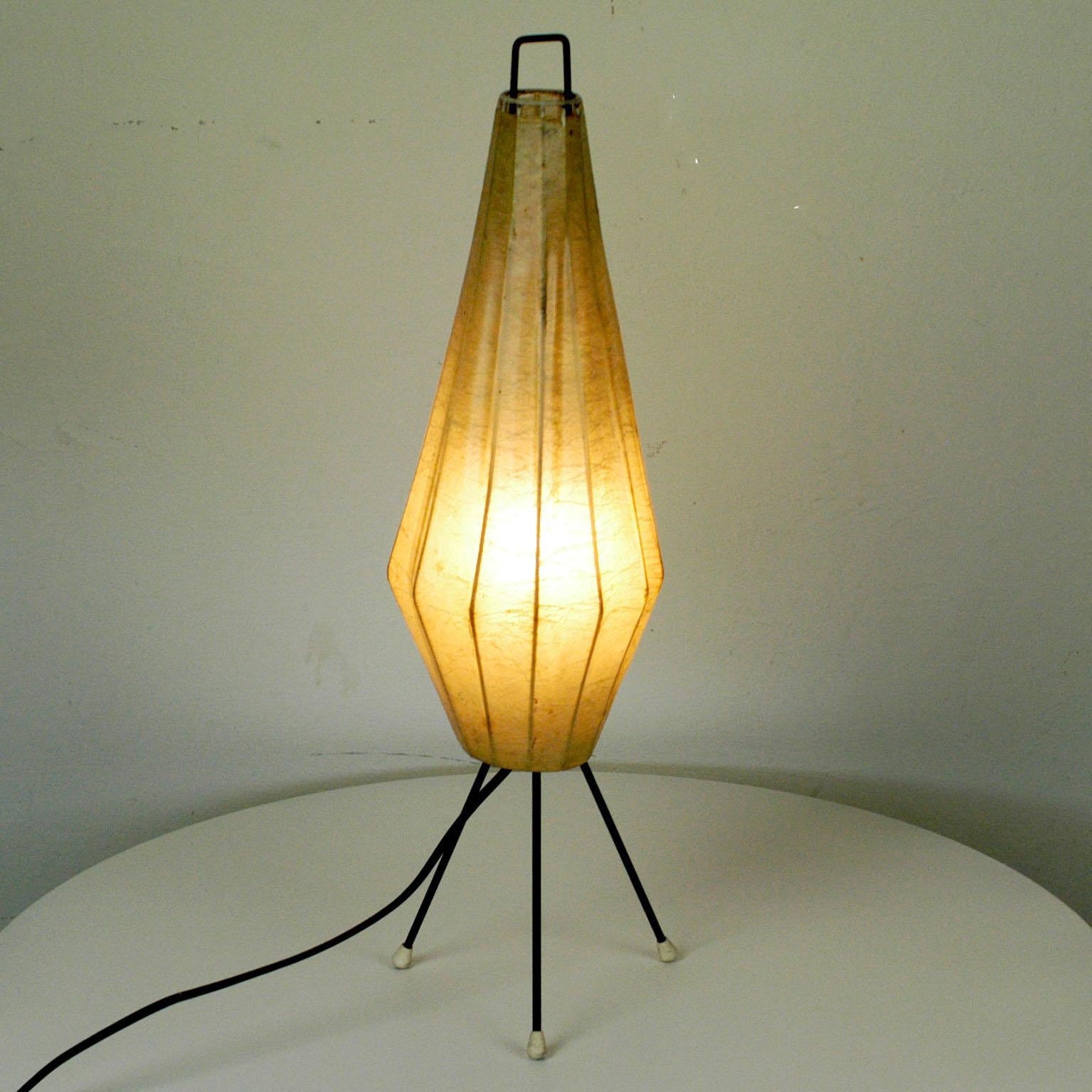 Charming midcentury tripod table lamp with cocoon shade and black lacquered metal base, one E14 light socket.