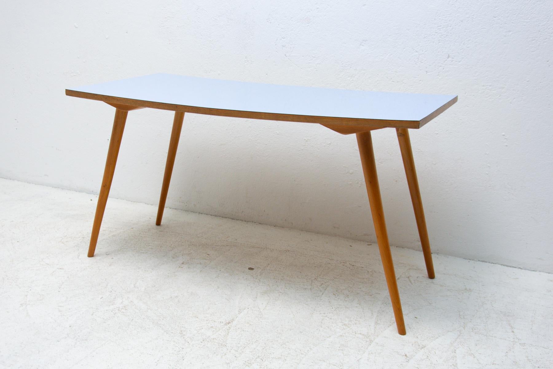 Mid century coffee table with a formica plate, it was made in the former Czechoslovakia in the 1960´s. Very interesting shaping. In very good vintage condition, just bears minor signs of age and use.