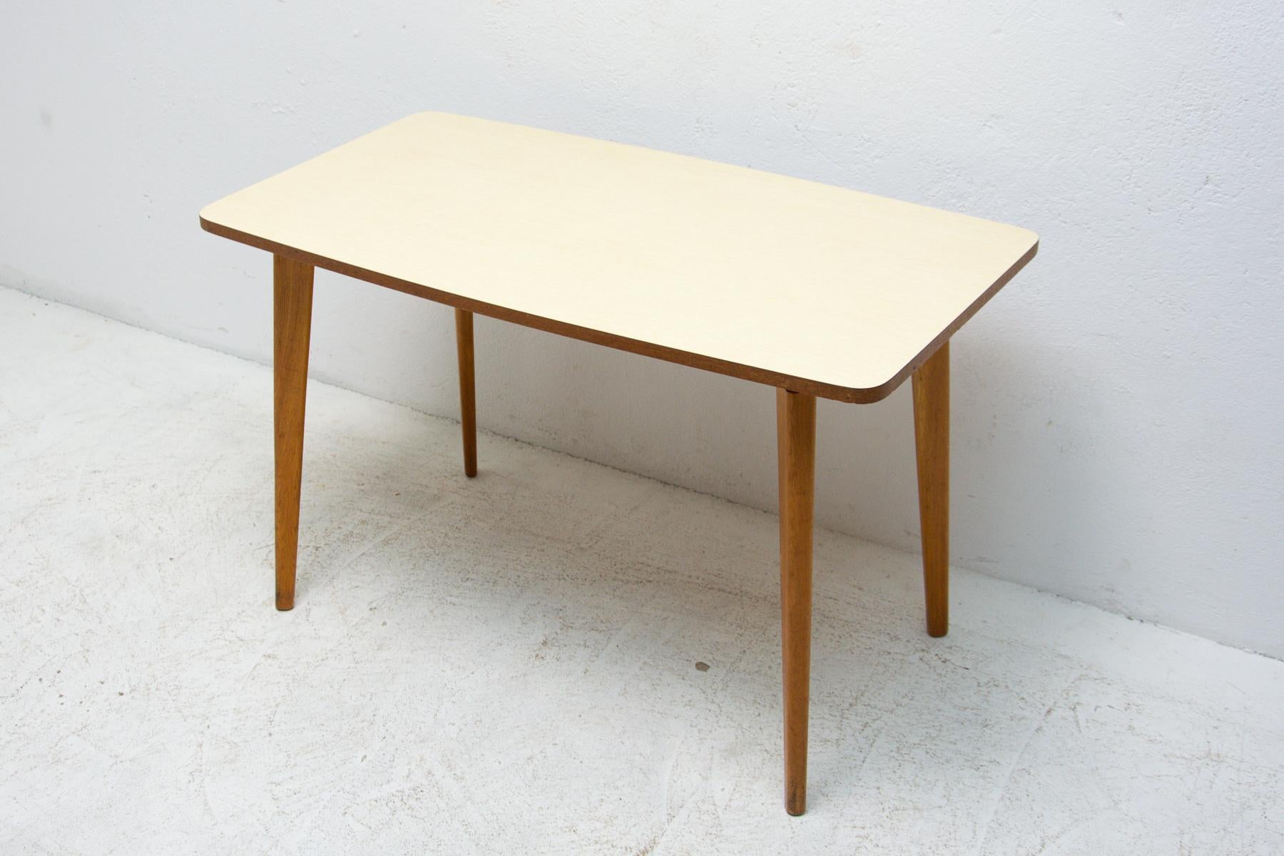 Mid Century coffee table with a formica plate, it was made in the former Czechoslovakia in the 1960s. Very interesting shaping. In very good Vintage condition, just bears minor signs of age and use.
     