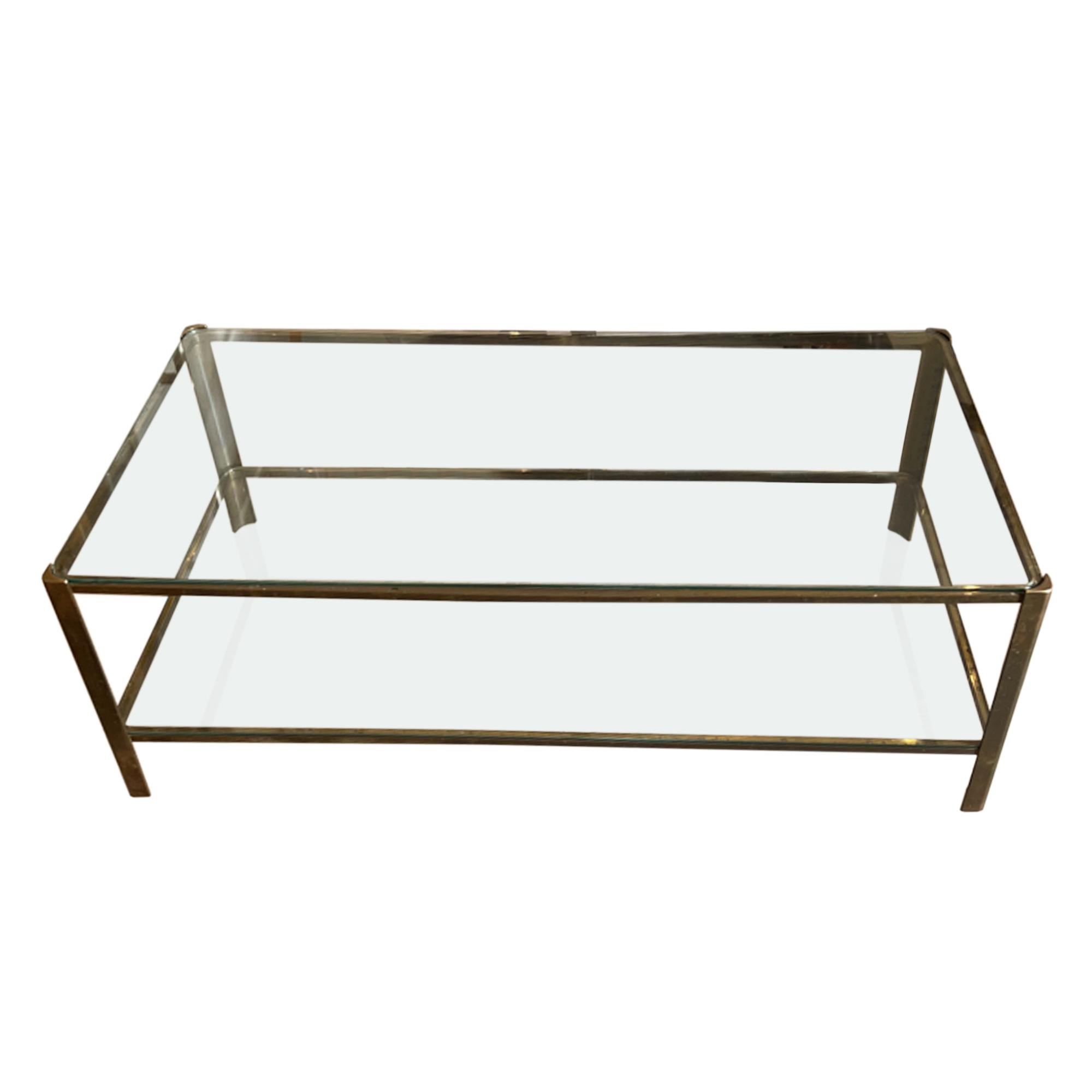 A super stylish design, this table is made from brass and glass. 

This is the two tier model - a great feature table in a living room and perfect for displaying your favouite large books. The height of the lower shelf is 11cm. 

Designed by Jacques