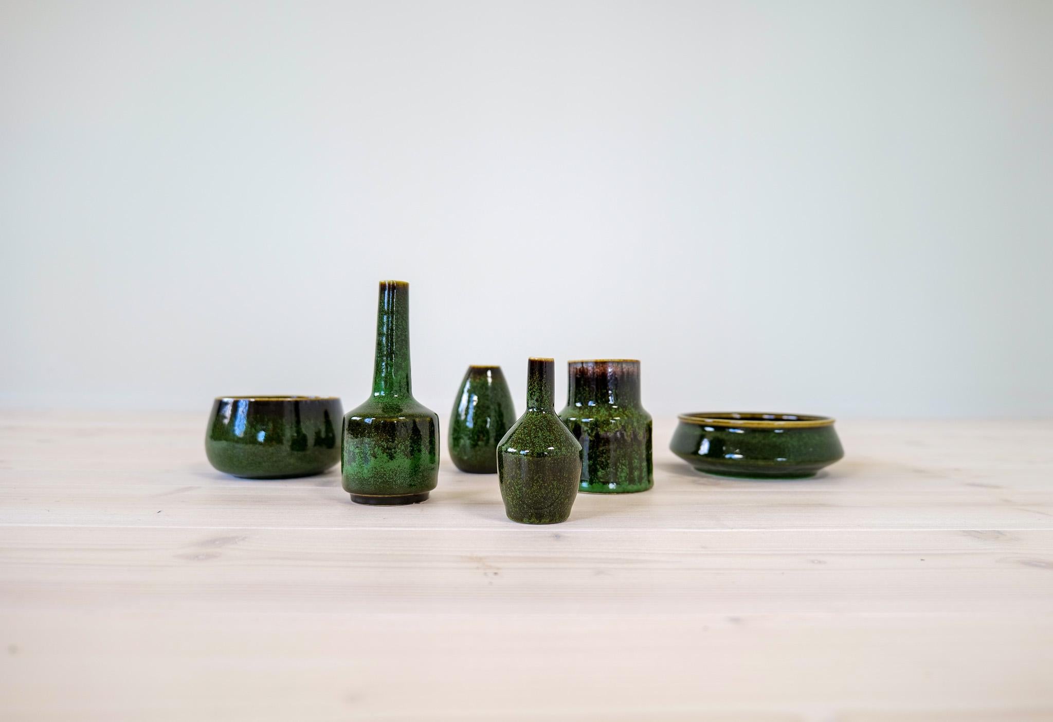Collection of vases and bowls from Rörstrand and maker/Designer Stålhane. Made in Sweden in the mid-century. Beautiful, glazed vases in good condition. This set of green vases and bowls are nice edition to any modern home. 

Dimensions: Vase’s