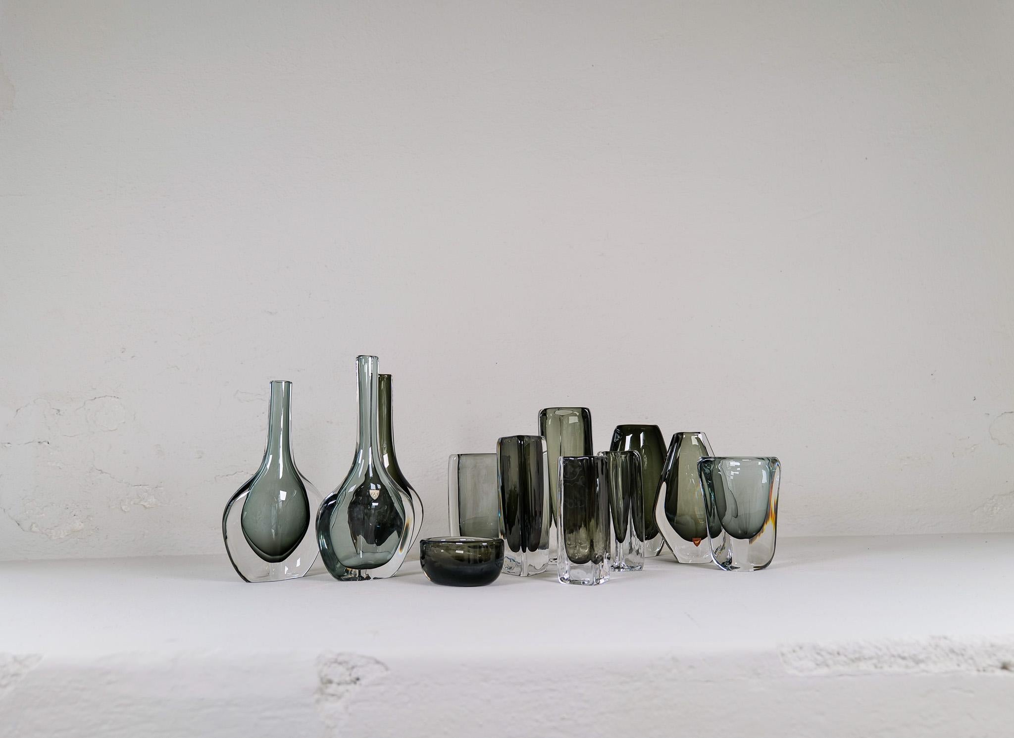 These 12 Swedish vintage Sommerso and dusk glass vases, produced circa 1950s-1960s by designer Nils Landberg for Orrefors, with smoked charcoal interior, cased within a clear layer. Great collection of different sizes and colors that all gives one