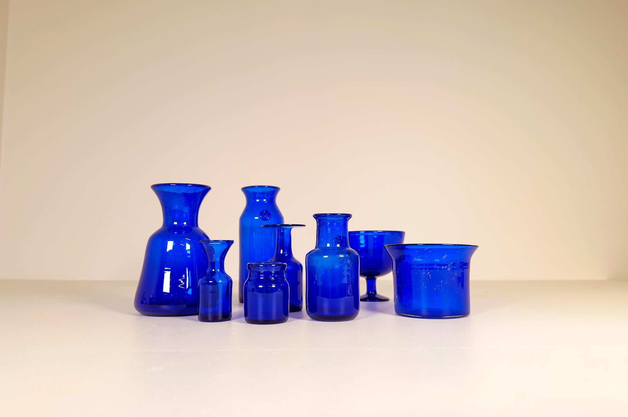 Collection of eight blue glass vases/vessels designed by Erik Höglund. Hand blown at Boda glass hut during the 1960s. They are all different sizes and shapes in very good to excellent condition. They are made in the typical method of Höglund where