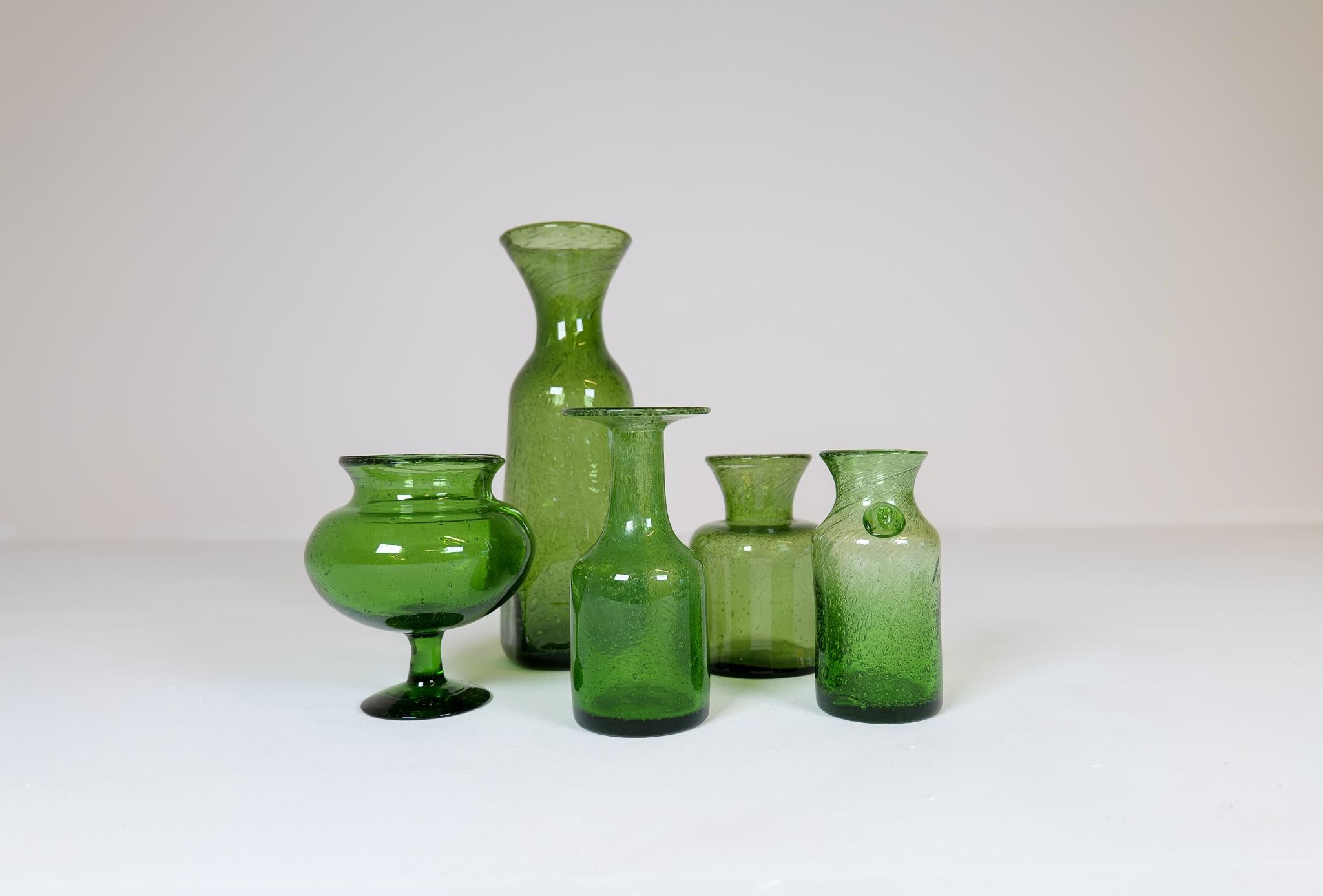 Collection of five green glass vases/vessels designed by Erik Höglund. Hand blown at Boda glass hut during the 1960s. They are all different sizes and shapes in very good to excellent condition. They are made in the typical method of Höglund where