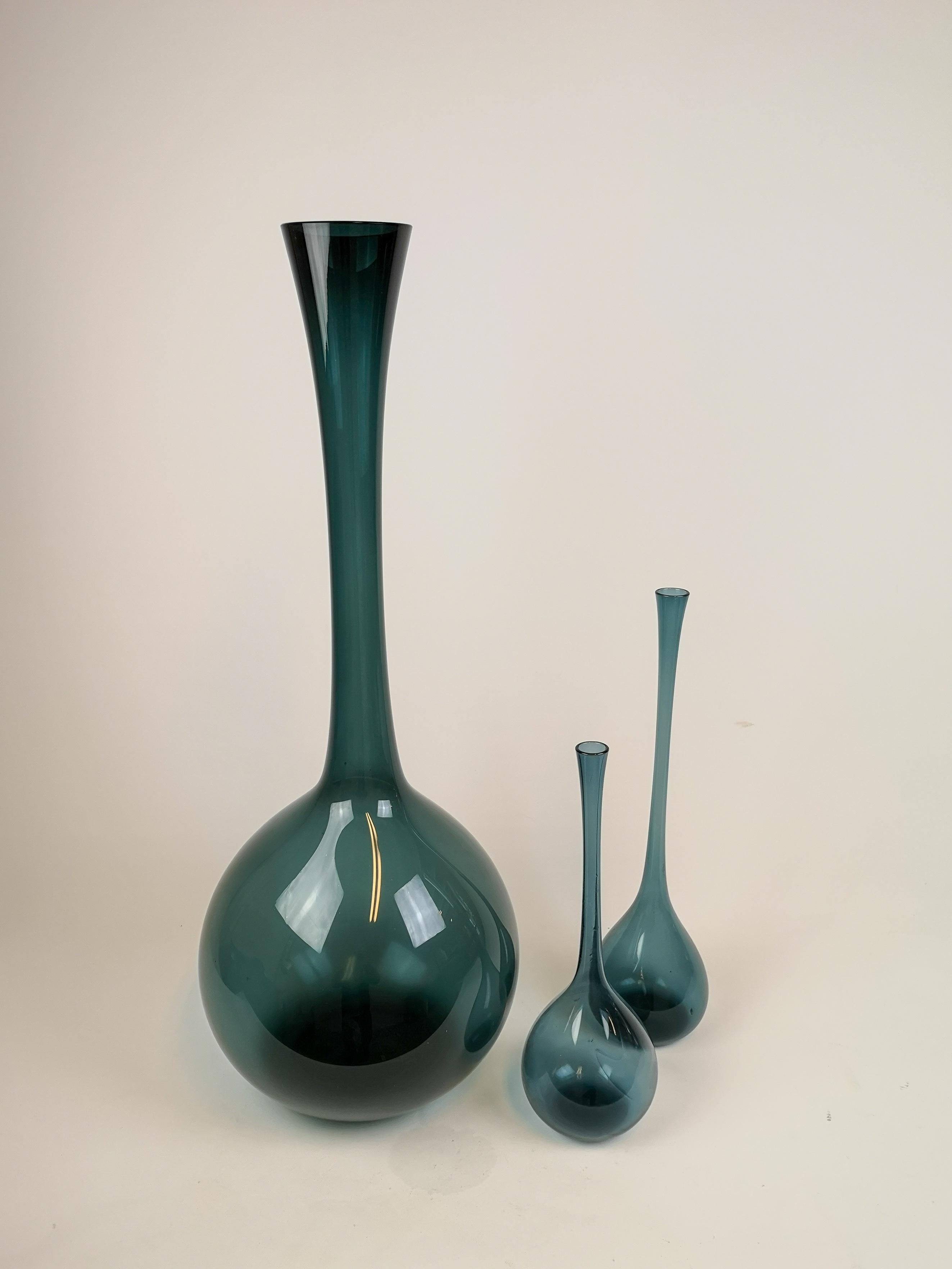 These three blue vases were made at Gullaskruf in sweden 1940s-1950s and designed by famous Arthur Percy. They are all in blue color and with different lengths. The large one 71 cm has a darker tone in its color. 

Good condition. 

Measures H