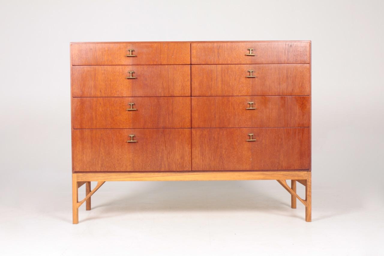 Commode in oiled teak on a base in oak. Designed by MAA. Børge Mogensen in the 1950s, this piece is made by CM Madsen cabinetmakers Denmark in the 1960s. Great restored condition.