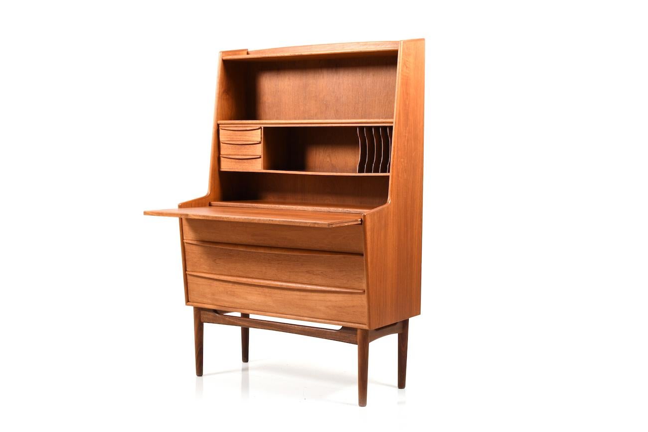 Midcentury conical Danish secretary in teak. Front with 3 big drawers, extendible writing surface and on top with open storage compartments and a small drawers.

Size:
46.0 / 66.5 x 90.0 x 141.0 CM ( D x W x H ), recording height: 71.5 CM.