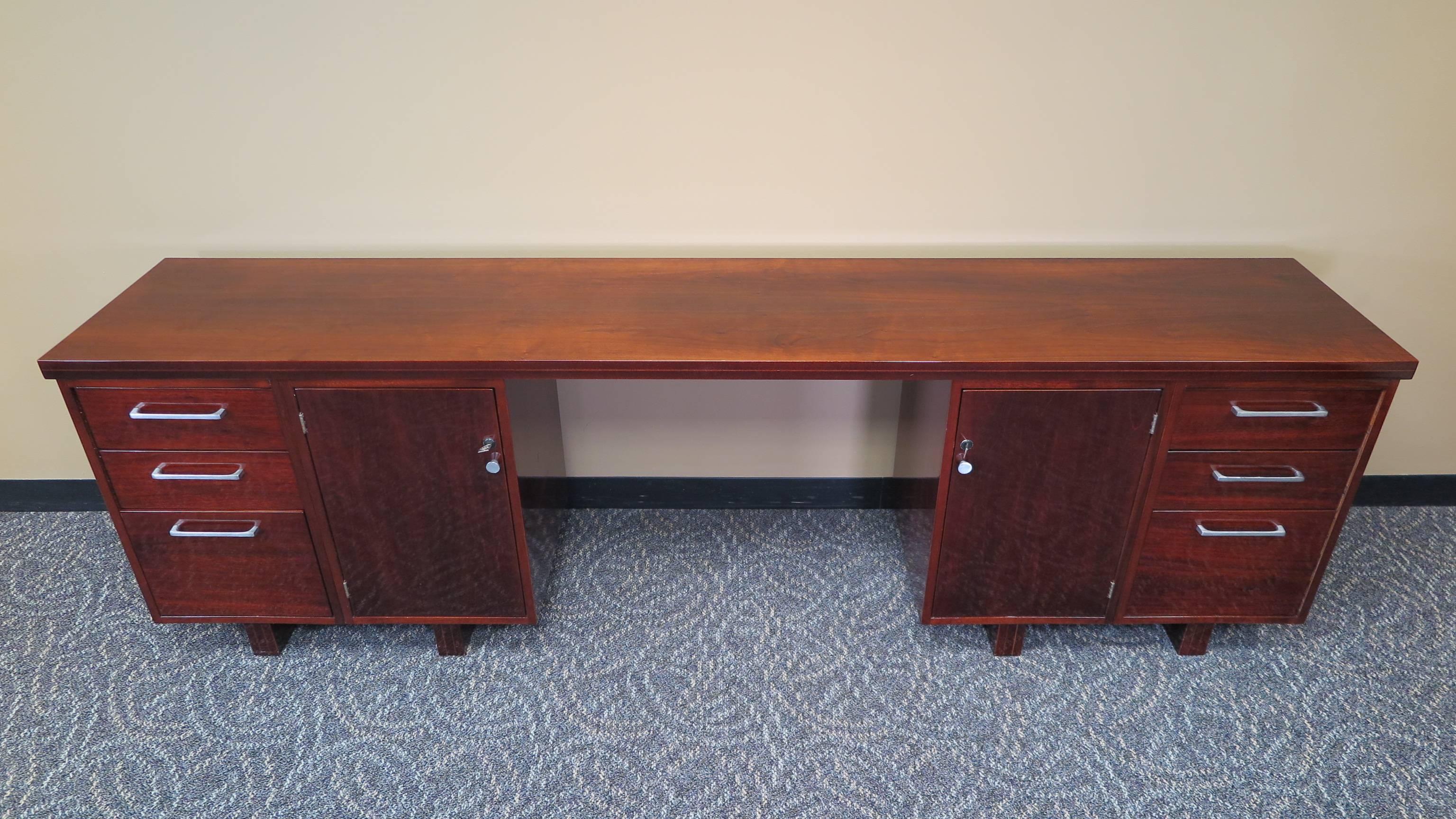 A midcentury console table desk, office console table. Mahogany work station console table with excellent storage. Four drawers, two file deep drawers and two locking cabinet storage compartments with shelf's. Includes two keys for both cabinet