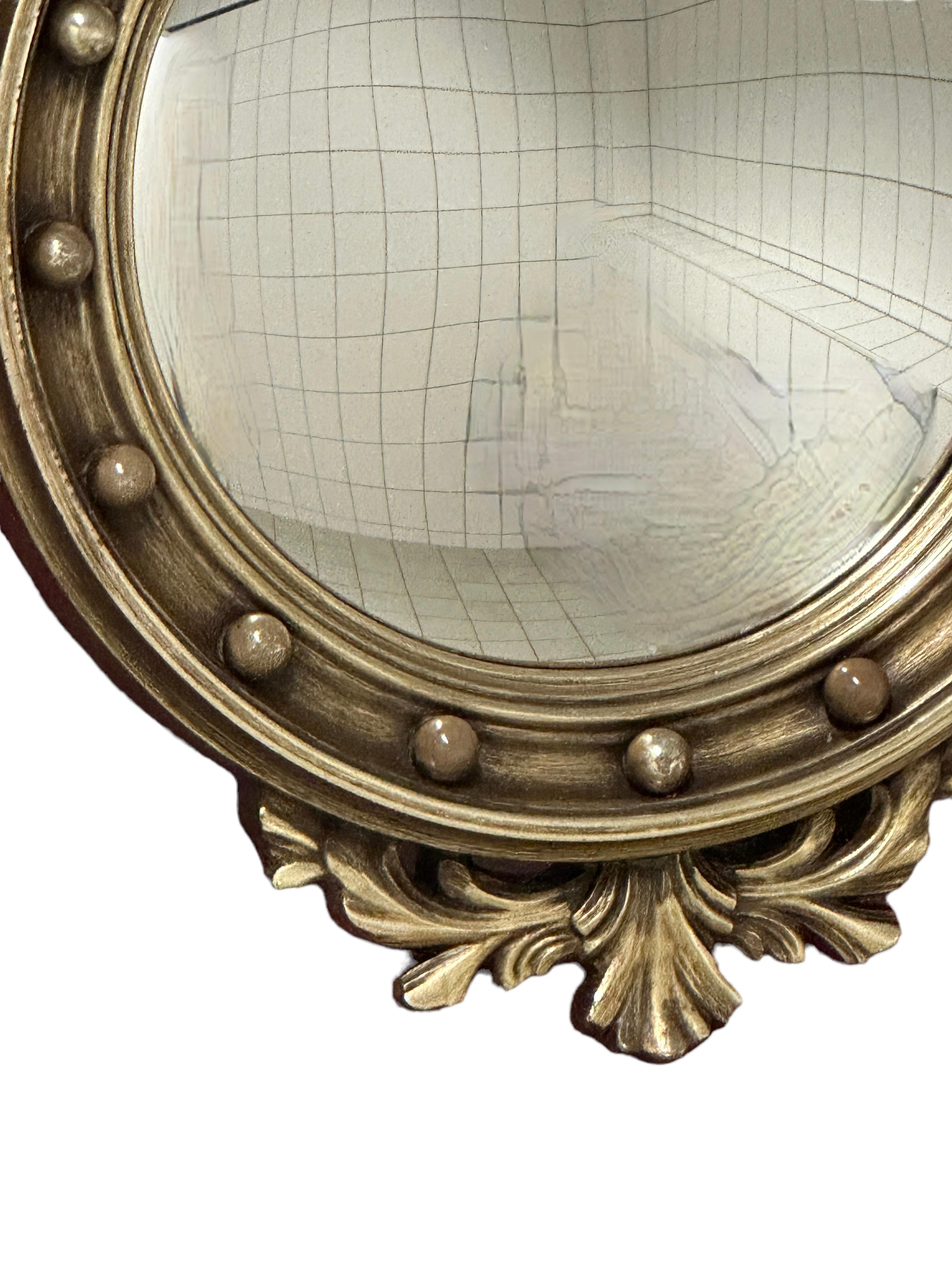 Gilded resin convex mirror with an eagle - sometimes referred to as 'butler' mirror or 'witch eye' mirror.
The golden mirror is in a very good condition. Beautiful eye catching mirror, ideal to add to a collection of sunburst mirrors. Mirror itself