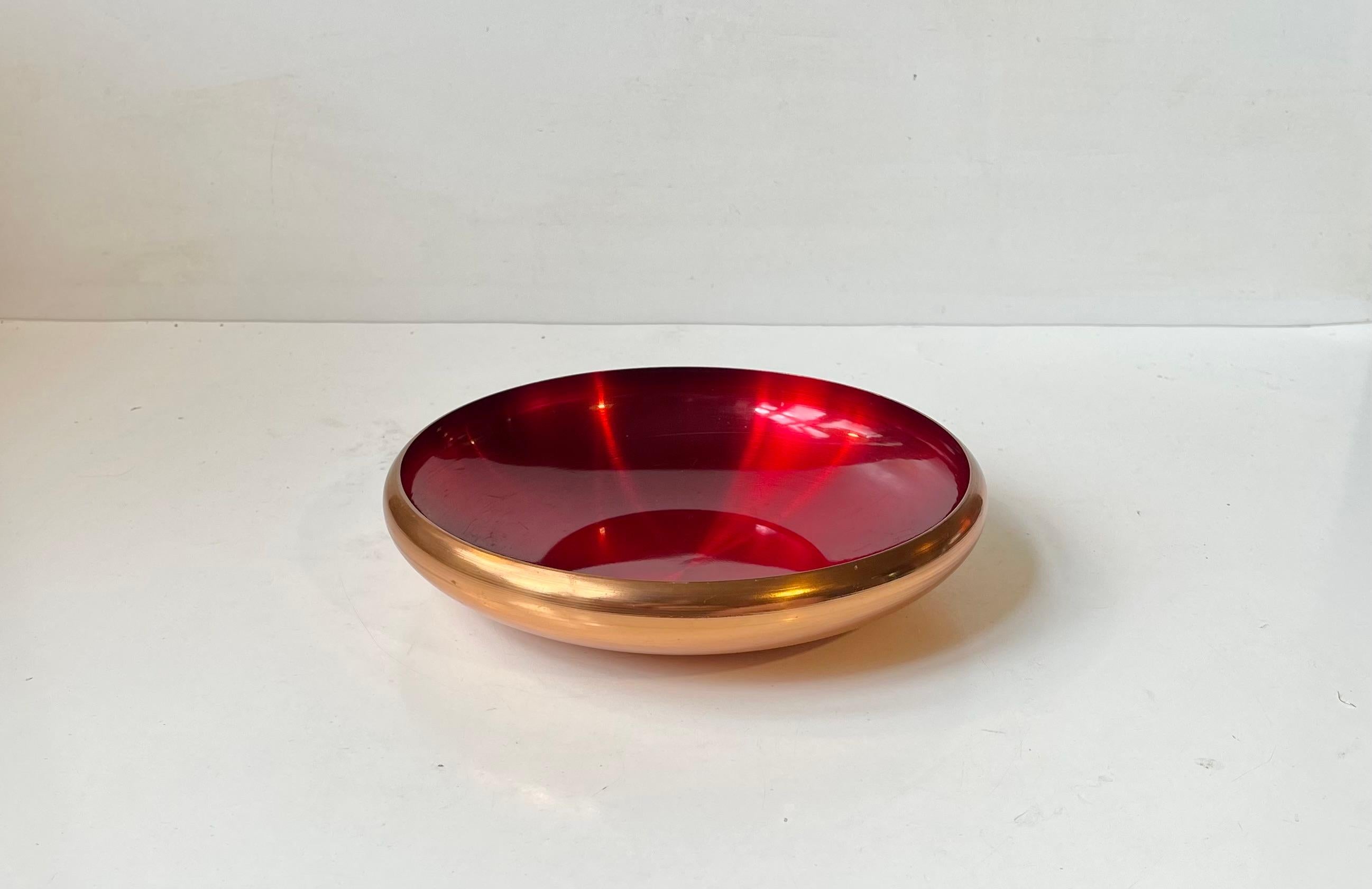 Norwegian solid Copper Bowl with interior ruby red enamel. Manufactured and designed by Odel Kobber in Norway during the 1960s. Stamped to the bottom. Measurements: D: 21 cm, H: 4.5 cm