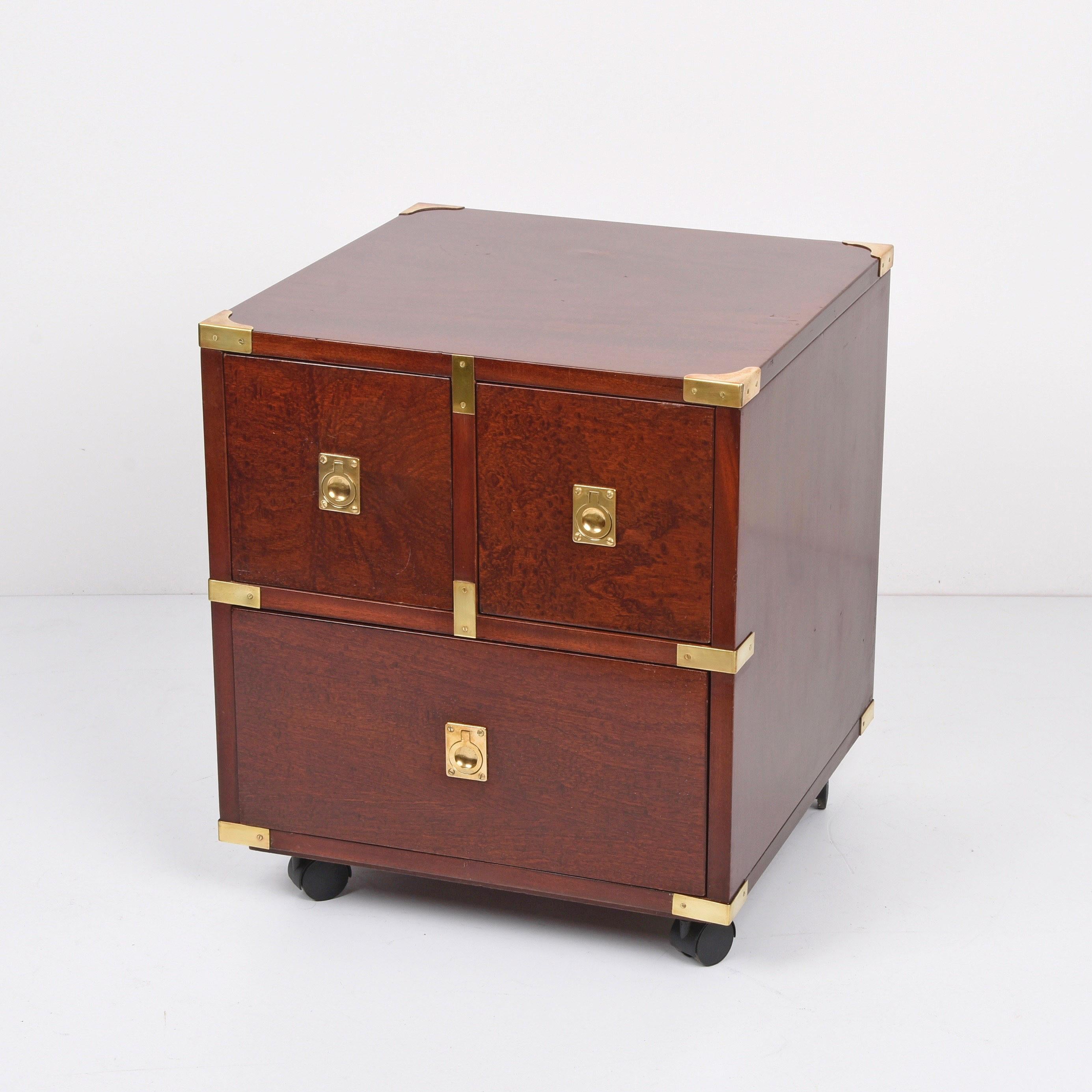 Wonderful nightstand midcentury country style three-drawer chest of drawers. This fantastic item is made of wood with brass hardware on casters.

A marvellous piece that has wonderful lines as it is almost cubical with the top two squared drawers
