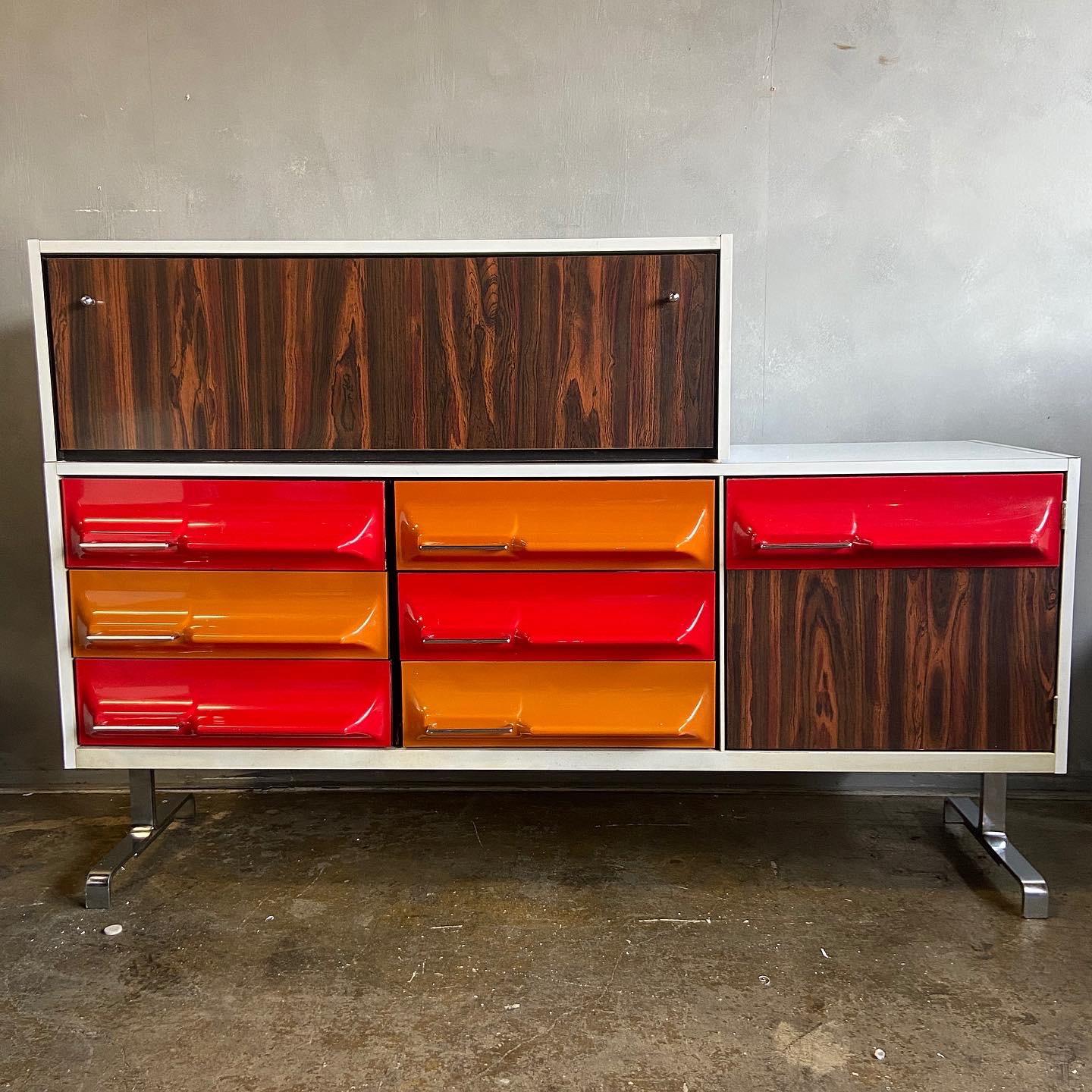 For  your consideration is this wonderful credenza designed by Giovanni Maur for Treco. A space age design featuring molded plastic fronts with laminate and rosewood details on a chrome base. This can can be used as a credenza or dresser and the top