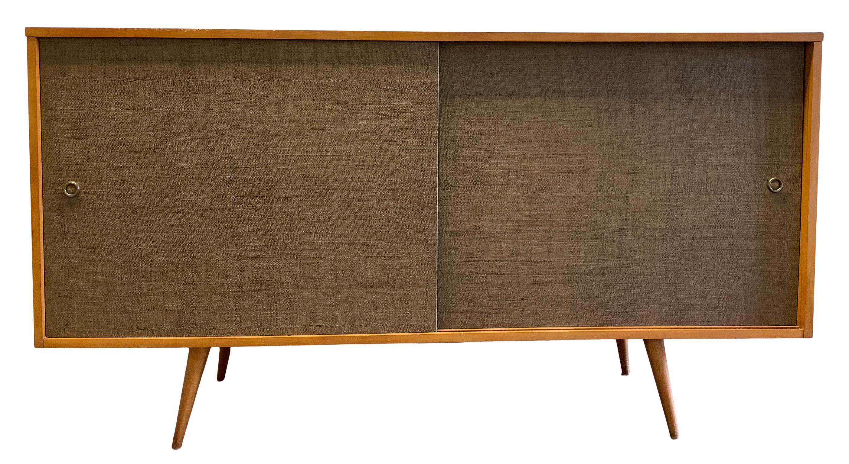 Beautiful midcentury tall credenza by Paul McCobb circa 1950 Planner Group #1514 has 1 adjustable shelves with pins with 1 drawer on the left side and 3 drawers on the right side. Solid maple construction with a Original Blonde Maple lacquer finish.