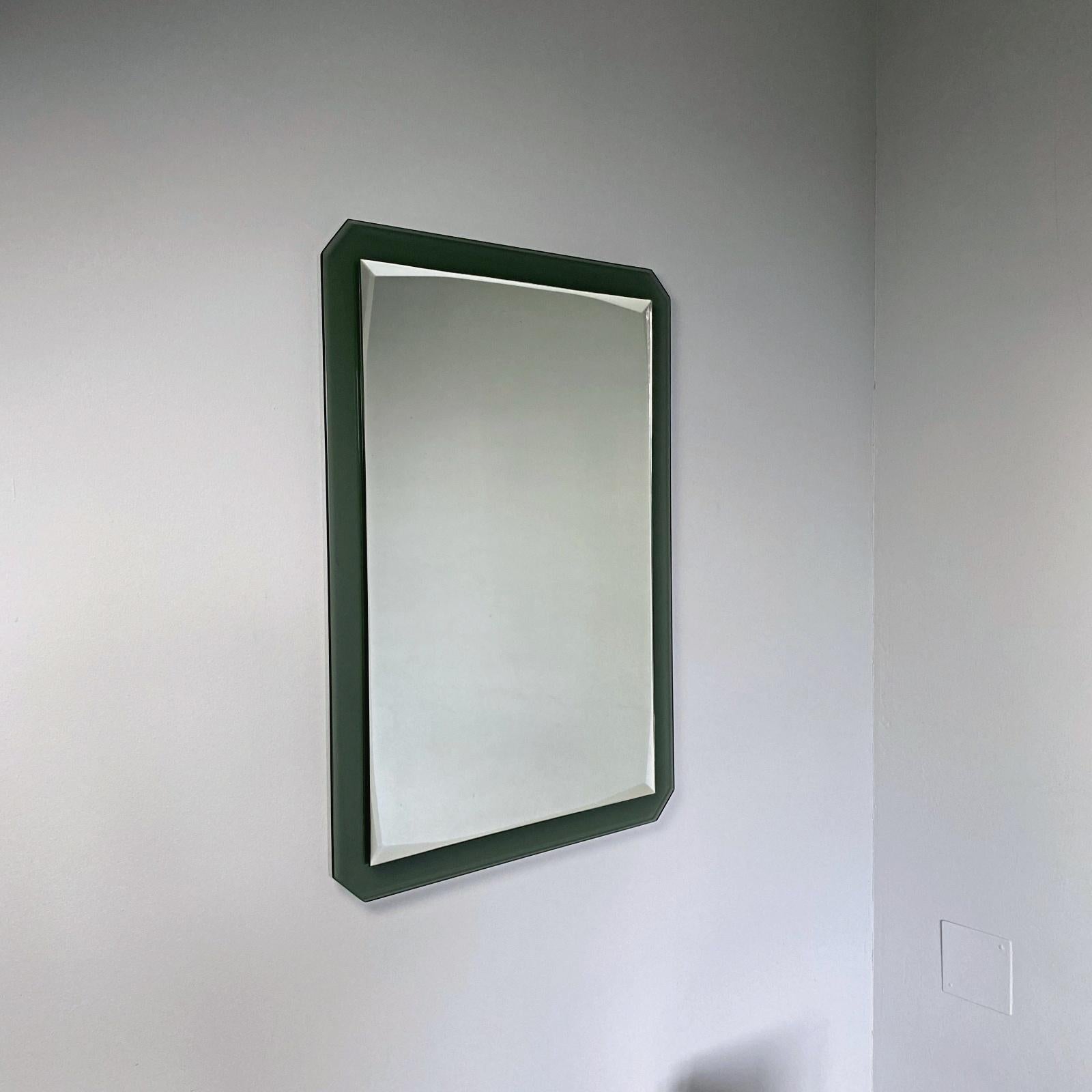 Beautiful rectangular midcentury faceted mirror with bottle green crystal glass frame made by Cristal Art in 1960s, Italy. The mirror can also be hung horizontally. The mirror is in a very good condition, without any chips or