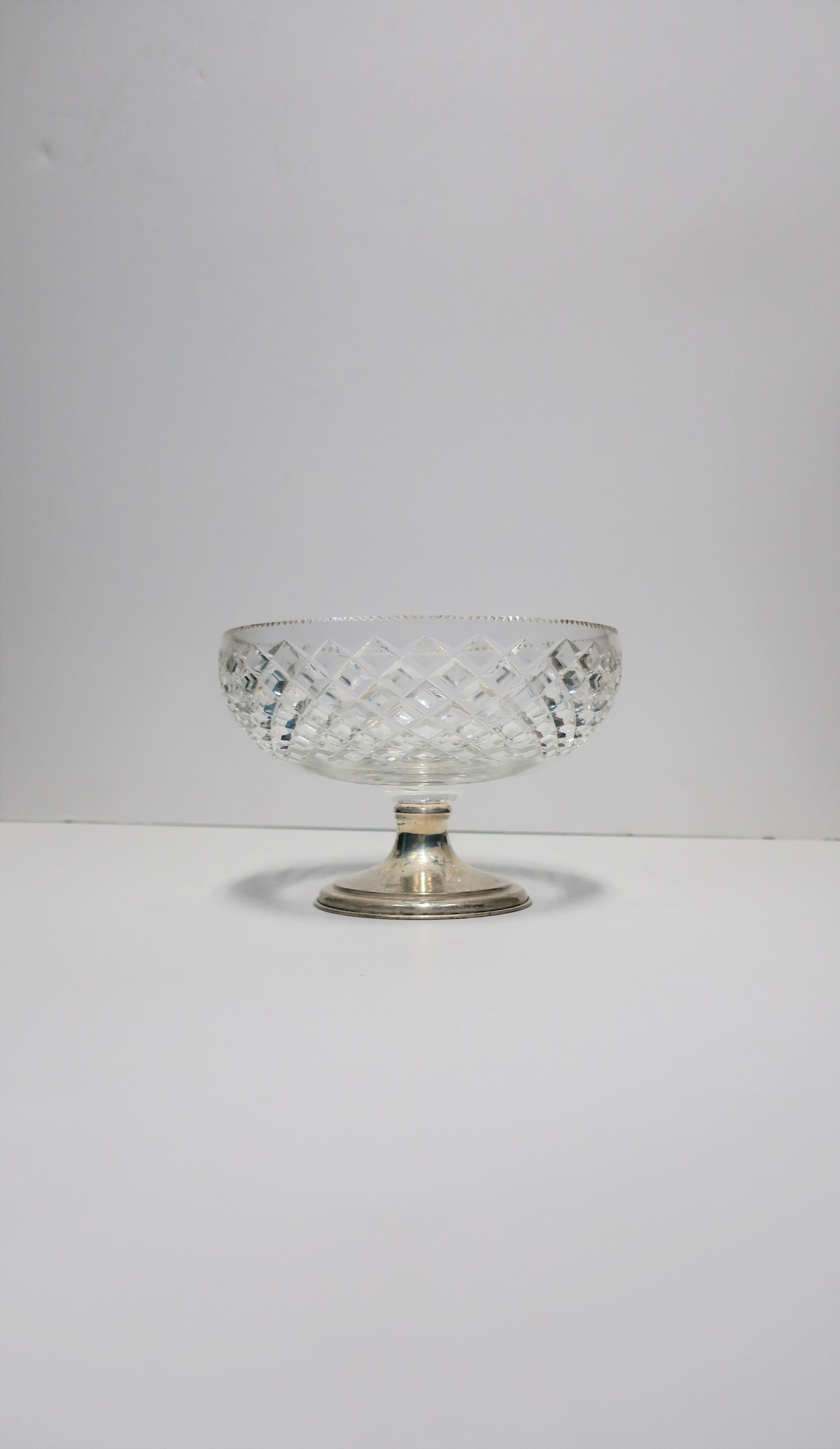 A beautiful crystal and sterling silver compote or footed bowl, by T. G. Hawkes & Co., circa early to mid-20th century, USA. Crystal bowl has cut diamond design and serrated edge with sterling silver base. Marker's mark and marked 'Sterling' on