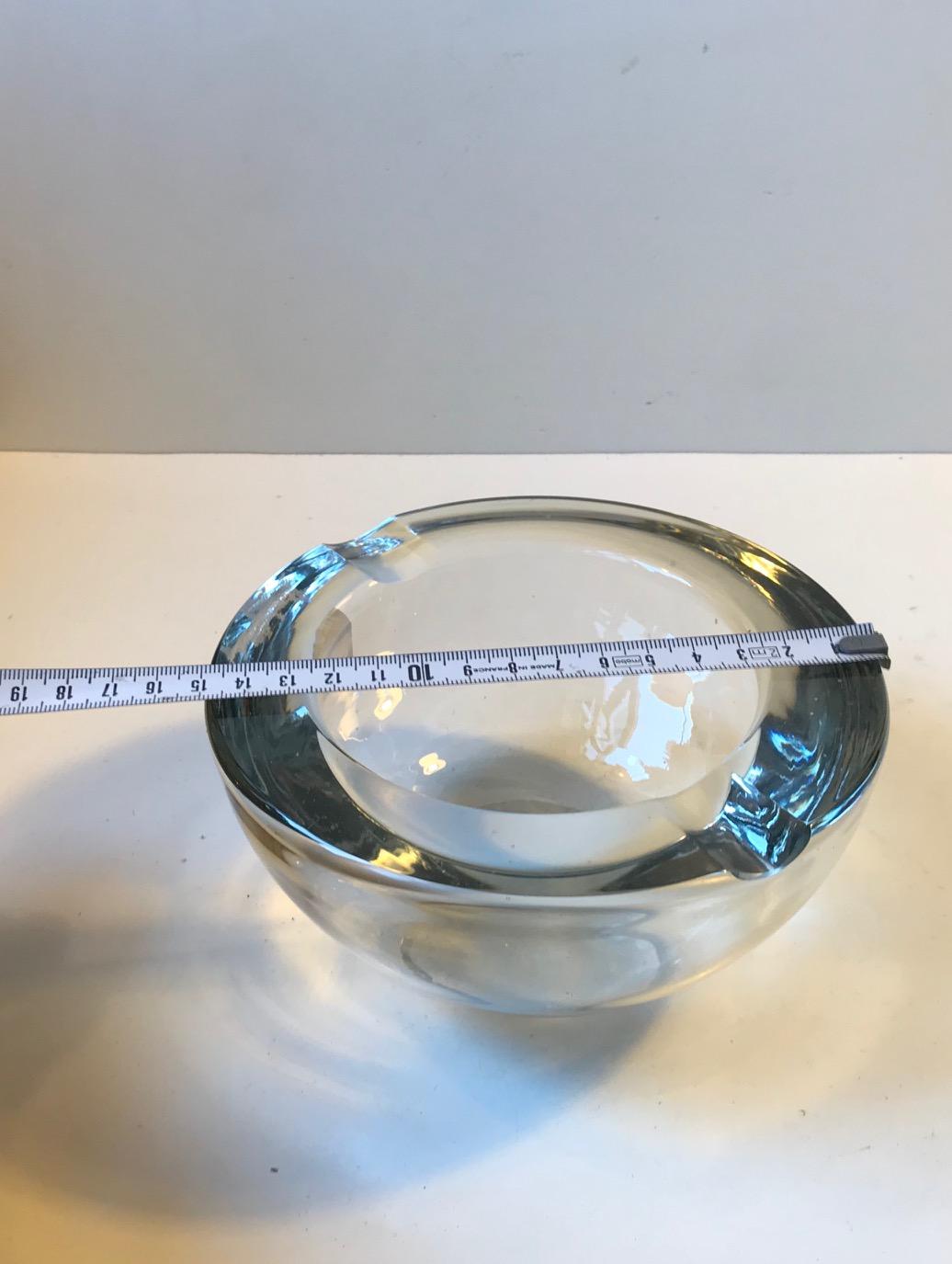 Thick and heavy cigar ashtray. It is made from polished lead crystal. Signed and numbered beneath its base. The signature looks like EH so it was probably designed by Erik Hoglund.