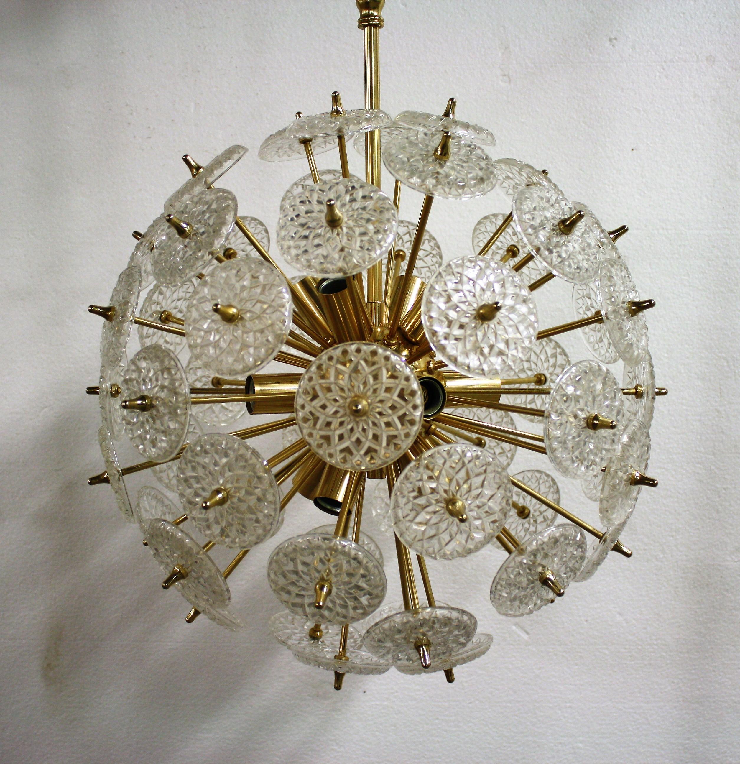 Impressive brass and crystal sputnik chandelier.

The crystals are made by the renowned Belgium glass company Val Saint Lambert.

The chandelier has 12 lightpoints that can be used with regular E14 candle light bulbs.

These chandeliers are