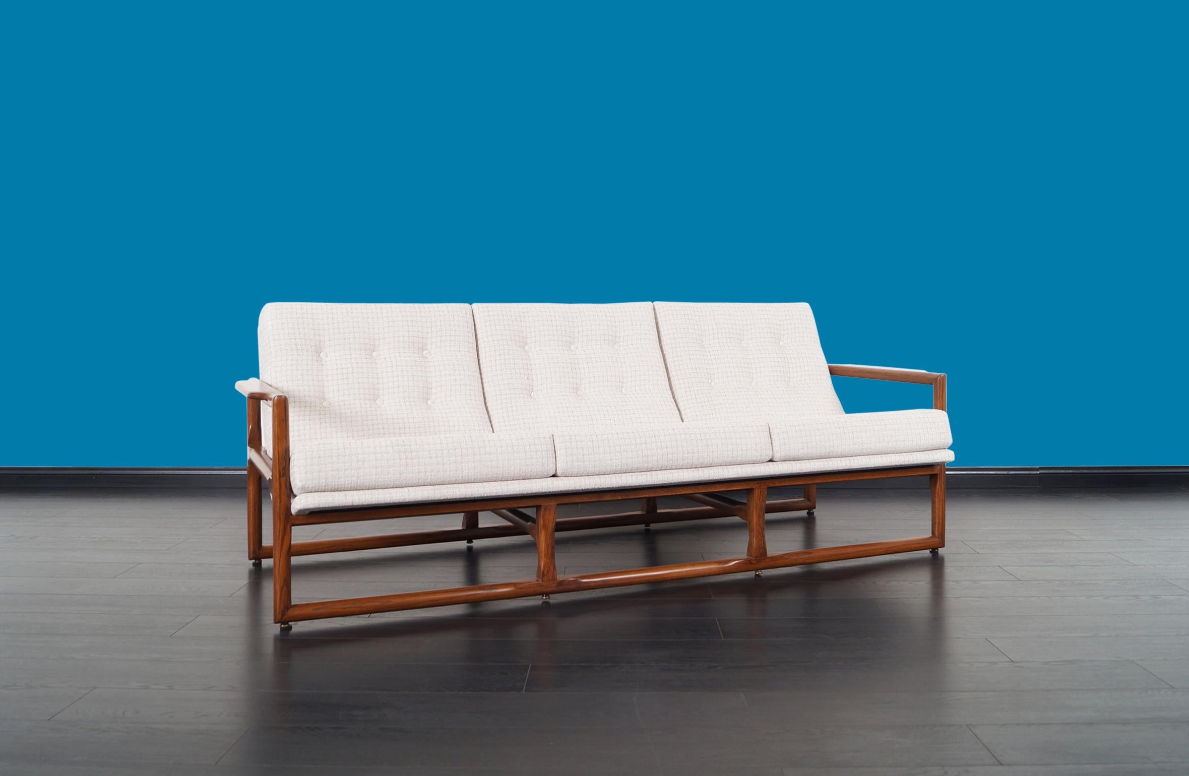 Exceptional mid-century “Cube” sofa designed attributed to Milo Baughman, circa 1970s. This wonderful sofa is characterized by its design and comfort, it has a solid walnut stain frame that wraps around the backrest giving the perfect color