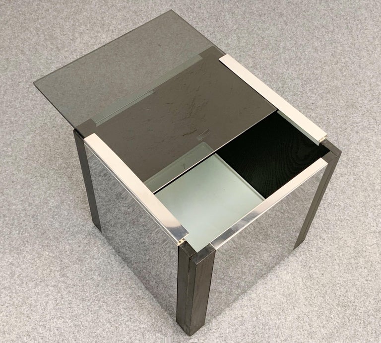 Unique midcentury cubic mirrored steel and glass dry bar with hidden wheels. This incredible piece of barware was probably designed by Willy Rizzo in Italy during 1970s.

This item has four sides are in mirrored steel, while the top is in flowing