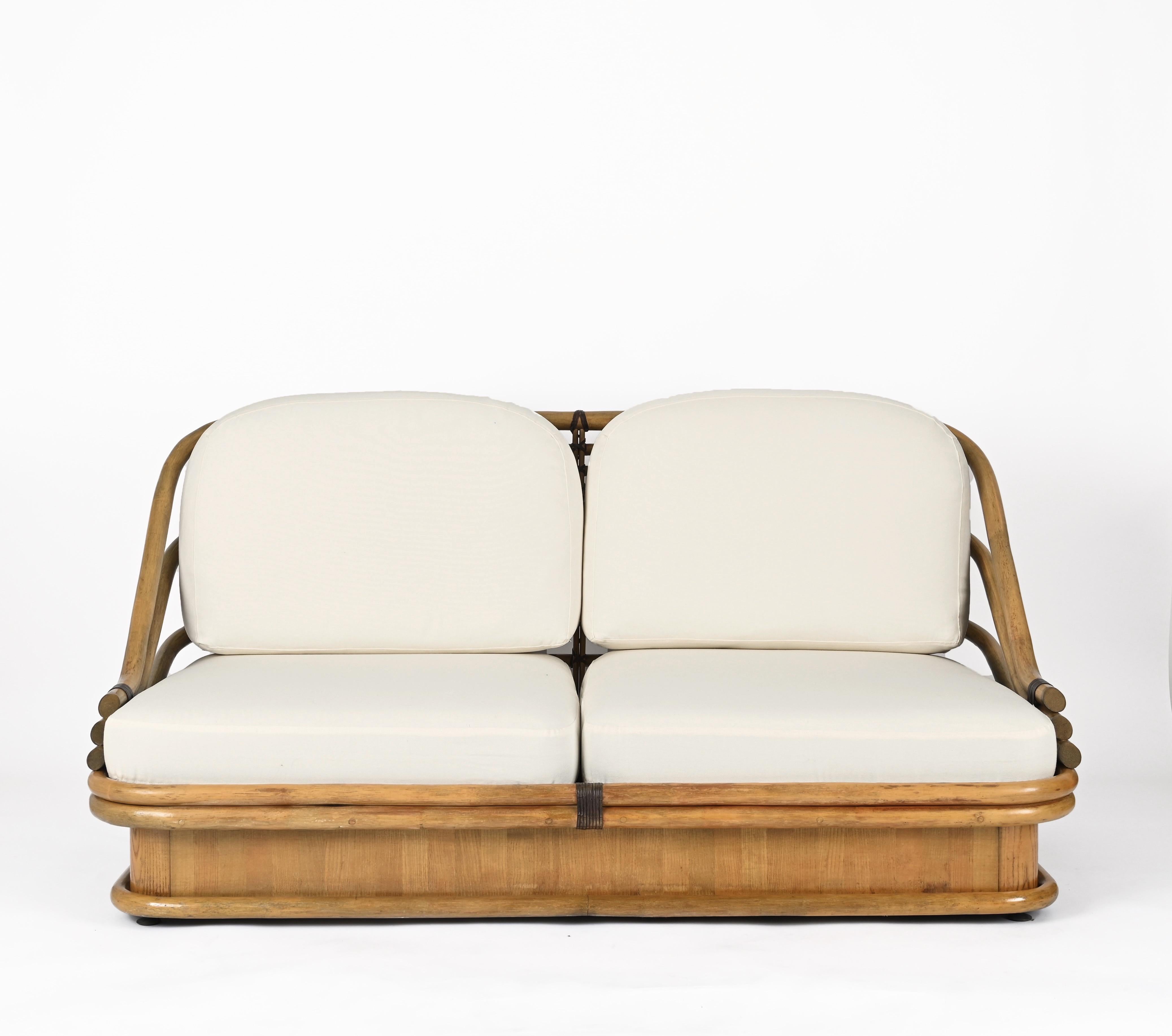 Fantastic Mid-Century organic sofa, fully made in bamboo, leather, and maple wood. This elegant piece was produced in Italy during the 1960s. with chestnut e and leather finishes. 

This sofa is incredible as it is made in a stunning combination of